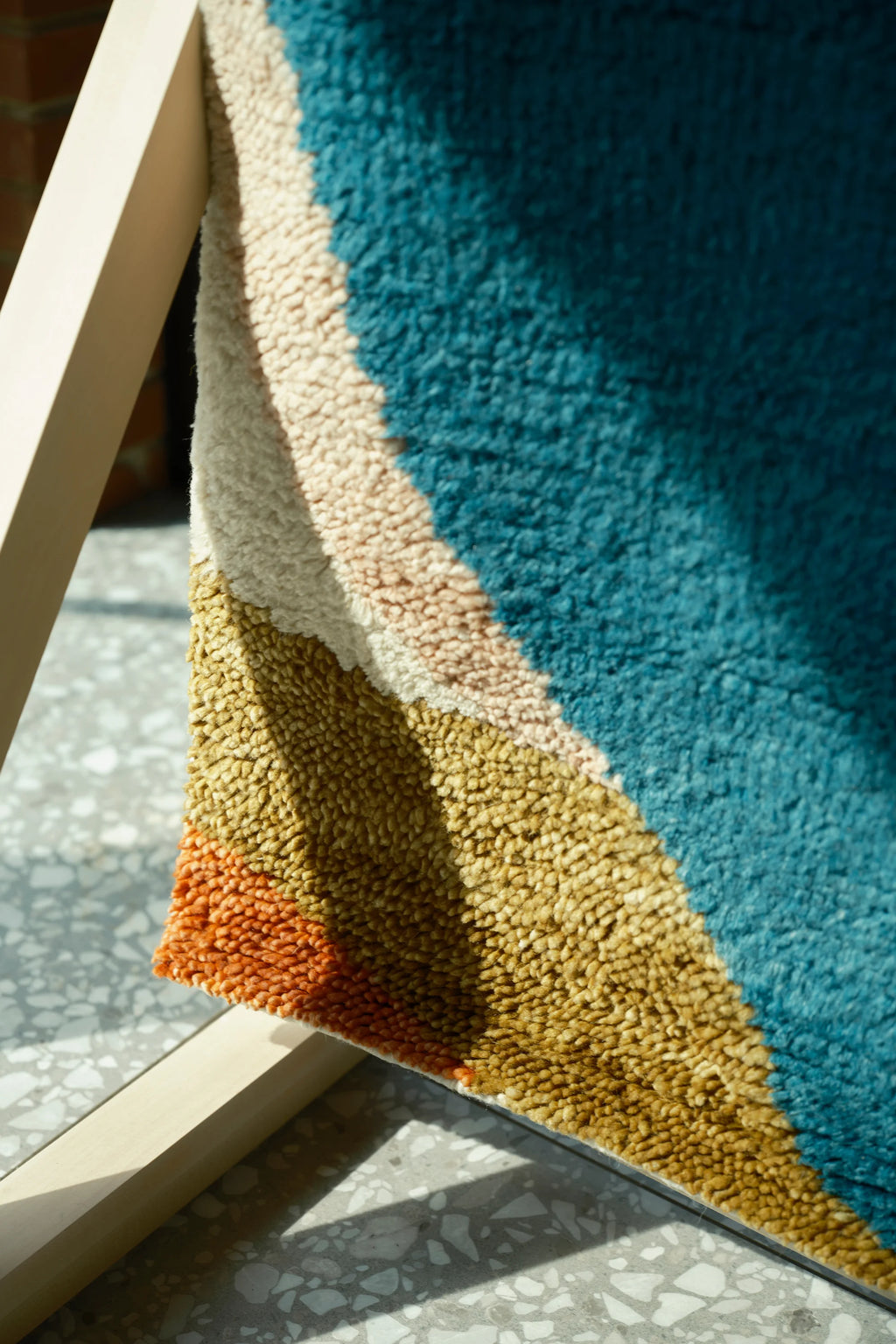 Layered Kaleidoscope Wool Rug, a vibrant modern area rug with a plush, textured pile, featuring abstract bands of teal, beige, gold, and orange. Perfect for adding a colorful, cozy touch to any liv...