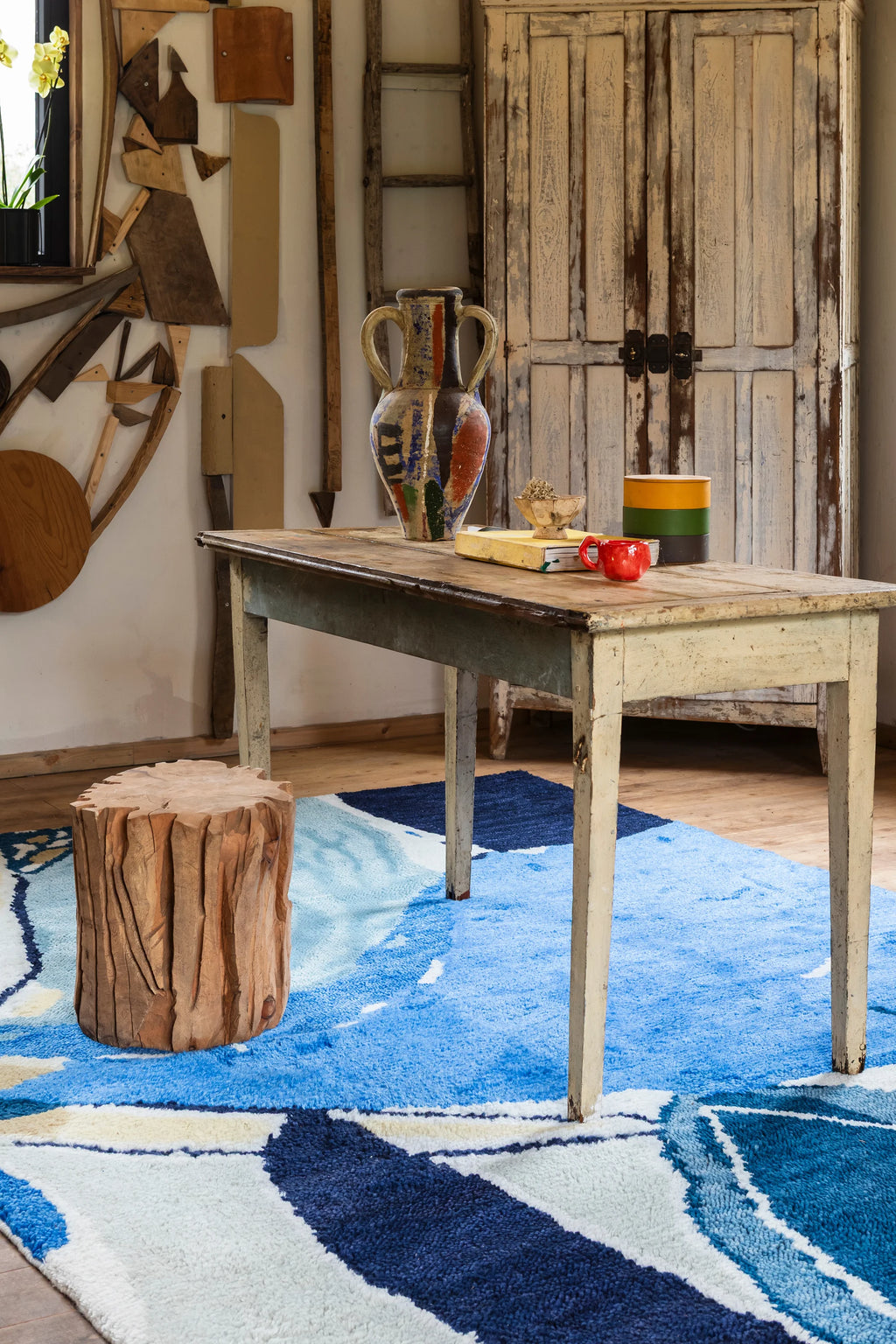 Layered Blue Lake Wool Rug, a vibrant abstract area rug featuring shades of blue, white, and yellow in an organic, flowing pattern. Perfect for adding a modern artistic touch to any living room or...