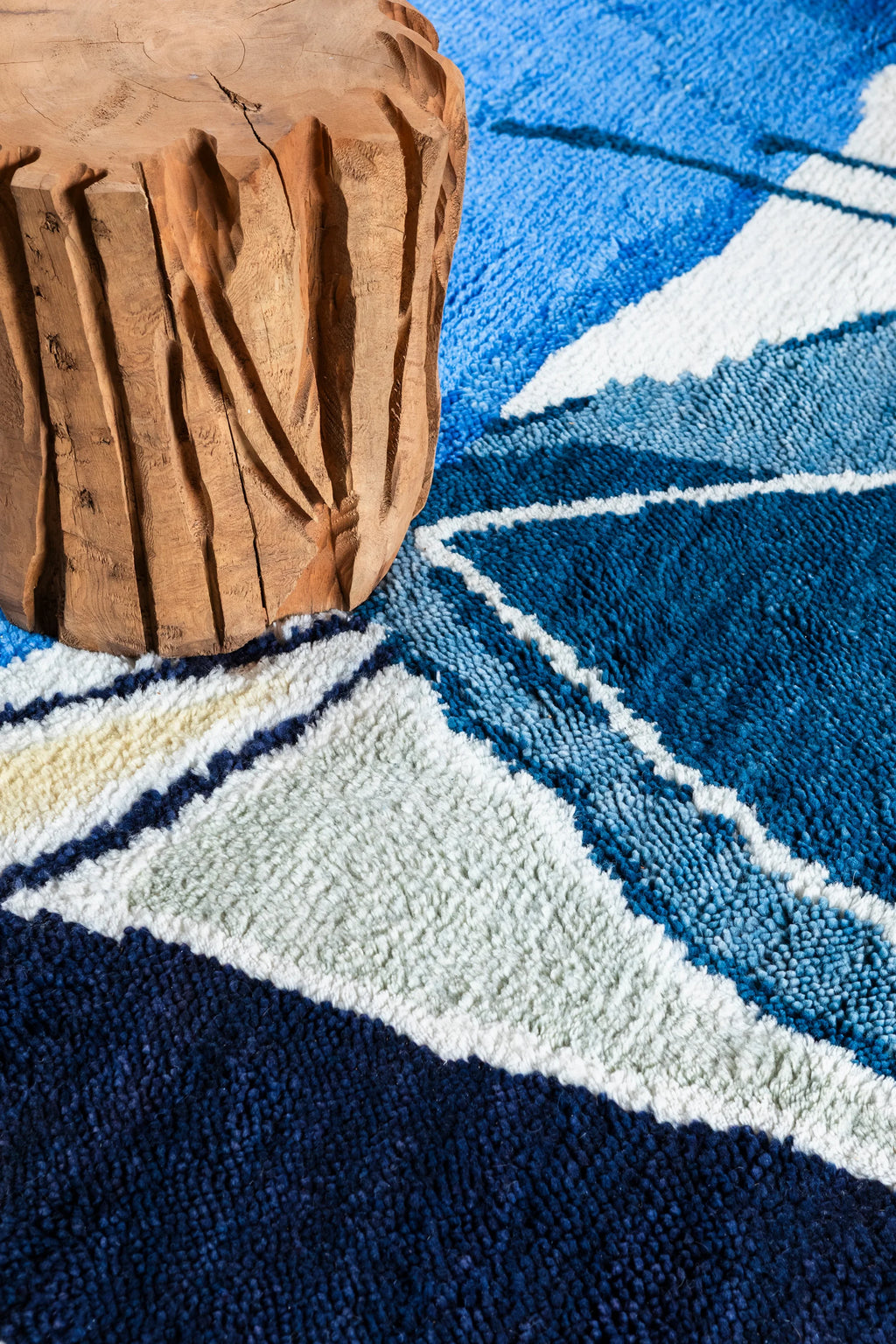 Layered Blue Lake Wool Rug, a plush textured rug in shades of blue, white, and pale green, featuring an abstract geometric pattern. Perfect for adding a modern touch and comfort to any living space.