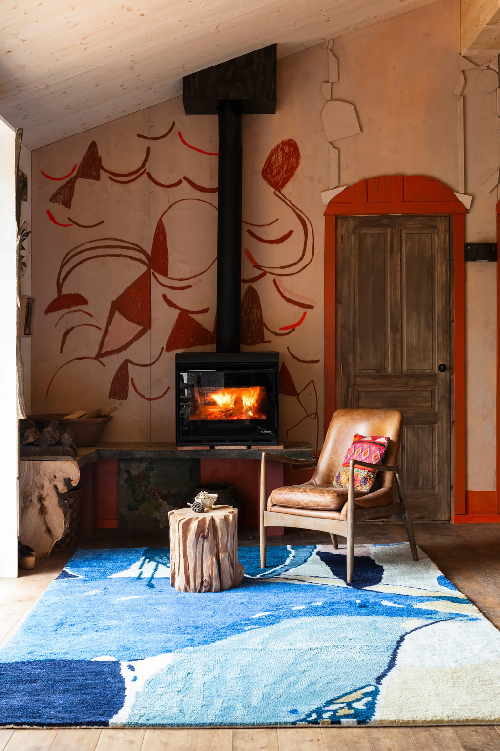 Layered Blue Lake Wool Rug, a vibrant abstract area rug in shades of blue and white, creating a flowing water-like design. Perfect for adding a calming, artistic touch to any living space or bedroom.