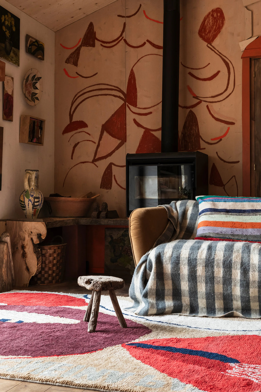 Layered Collage Wool Rug, a vibrant modern area rug with abstract shapes in red, burgundy, cream, and blue, featuring a plush, textured pile. Perfect for adding a bold, artistic statement to any li...