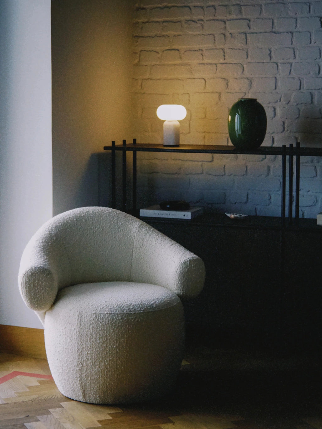 TAMO Conva Lounge Chair, an organic modern accent chair upholstered in a luxurious cream bouclé fabric with a soft, textured finish and a sculptural, rounded silhouette. This contemporary armchair features a low-profile design with seamless curved arms and a plush, inviting seat. Perfect for adding a touch of sophisticated comfort to a modern minimalist living room, cozy bedroom, or chic reading nook.