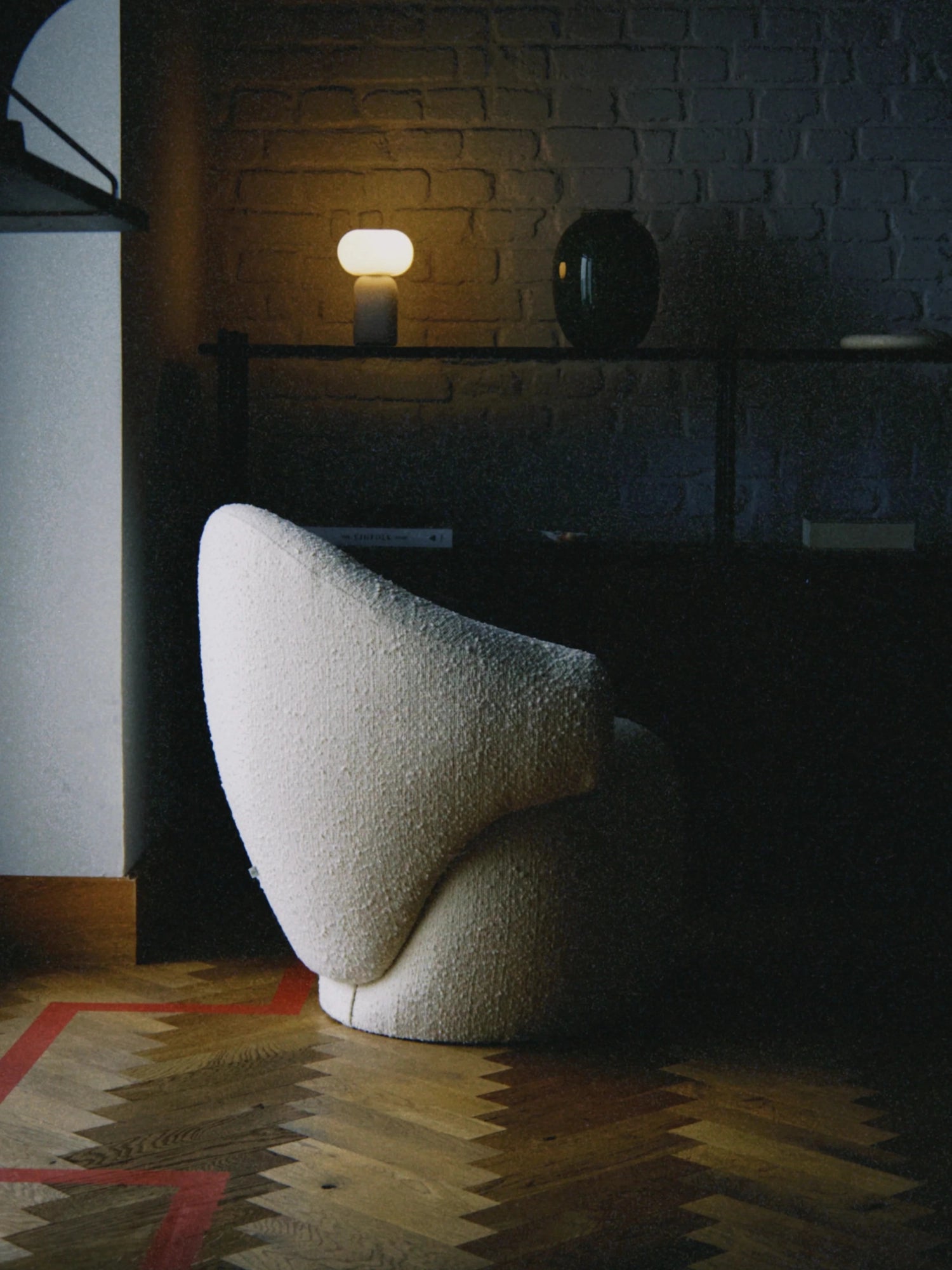TAMO Conva Lounge Chair, an inviting organic modern accent chair upholstered in a plush cream bouclé fabric with a distinctive sculptural, armless profile and soft, curved lines. This contemporary lounge chair is perfect for adding a cozy yet chic touch to minimalist living rooms or a luxurious bedroom reading nook.