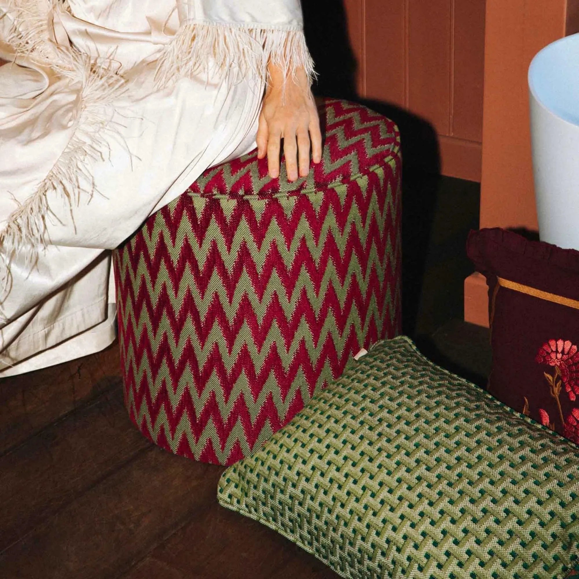 Hand-crafted beige and white knit Rosita Pouf with tassel accents