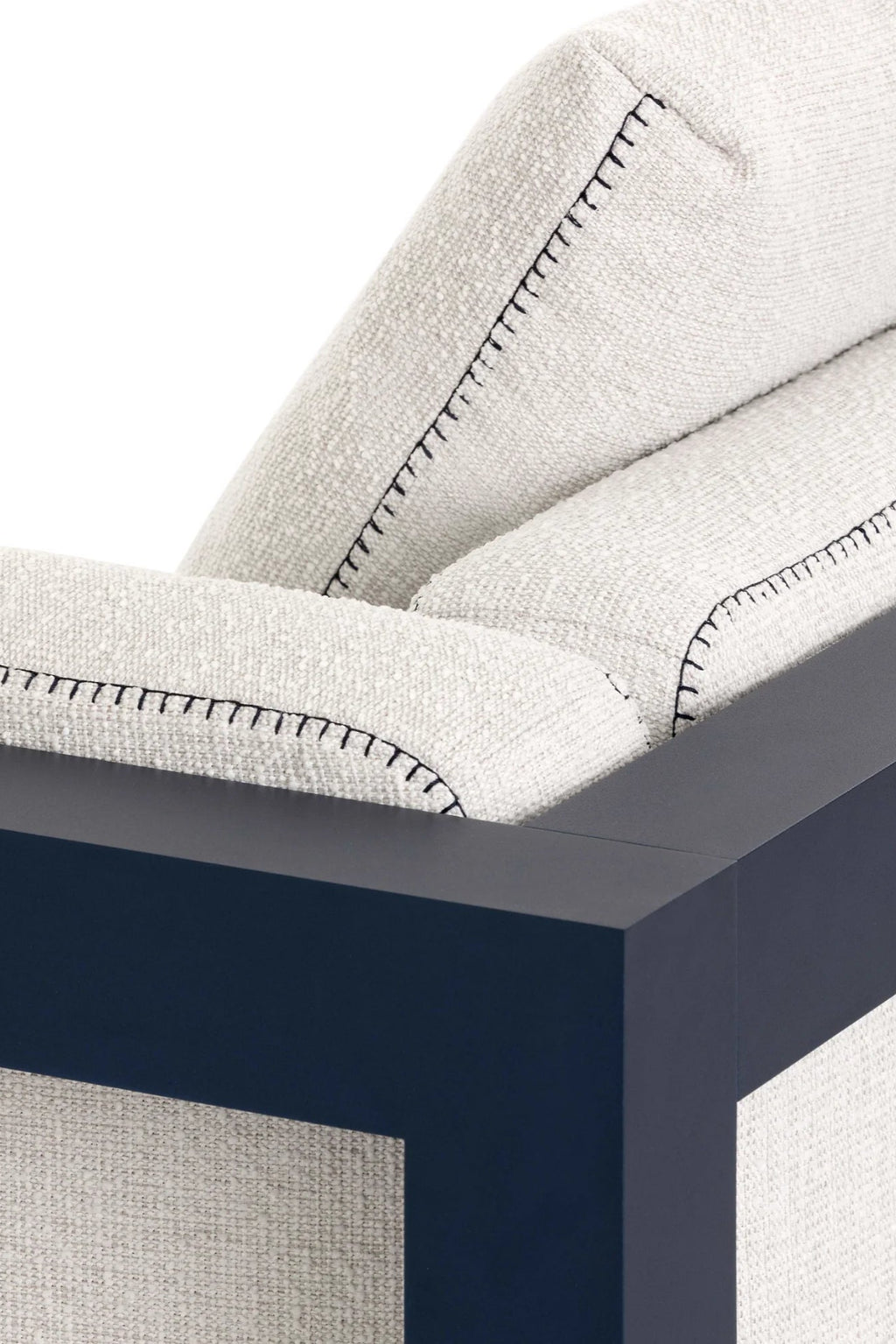 Gandia Blasco Islablanca Outdoor Lounge Chair, a modern minimalist outdoor armchair featuring a dark navy matte metal frame and plush cream-colored textured outdoor fabric upholstery with distinctive black decorative stitching along the edges. Ideal for contemporary patio living rooms and luxury outdoor spaces.