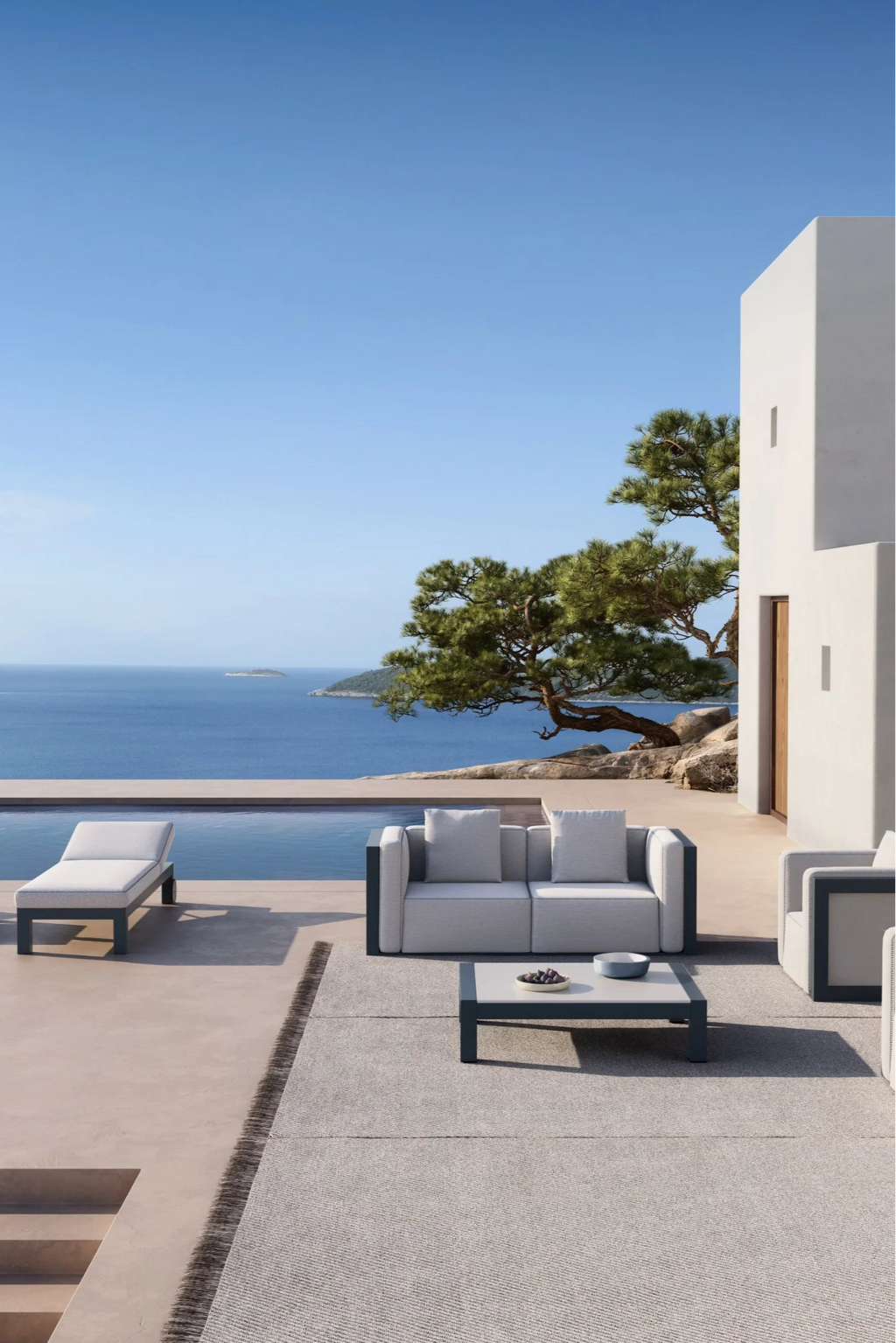 Gandia Blasco Islablanca Outdoor Chaise Lounge, a sleek modern minimalist sunbed featuring a matte dark grey aluminum frame and plush light grey outdoor fabric cushions. This contemporary pool lounge offers a low-profile design, perfect for luxury outdoor spaces, poolside decks, and coastal terraces.