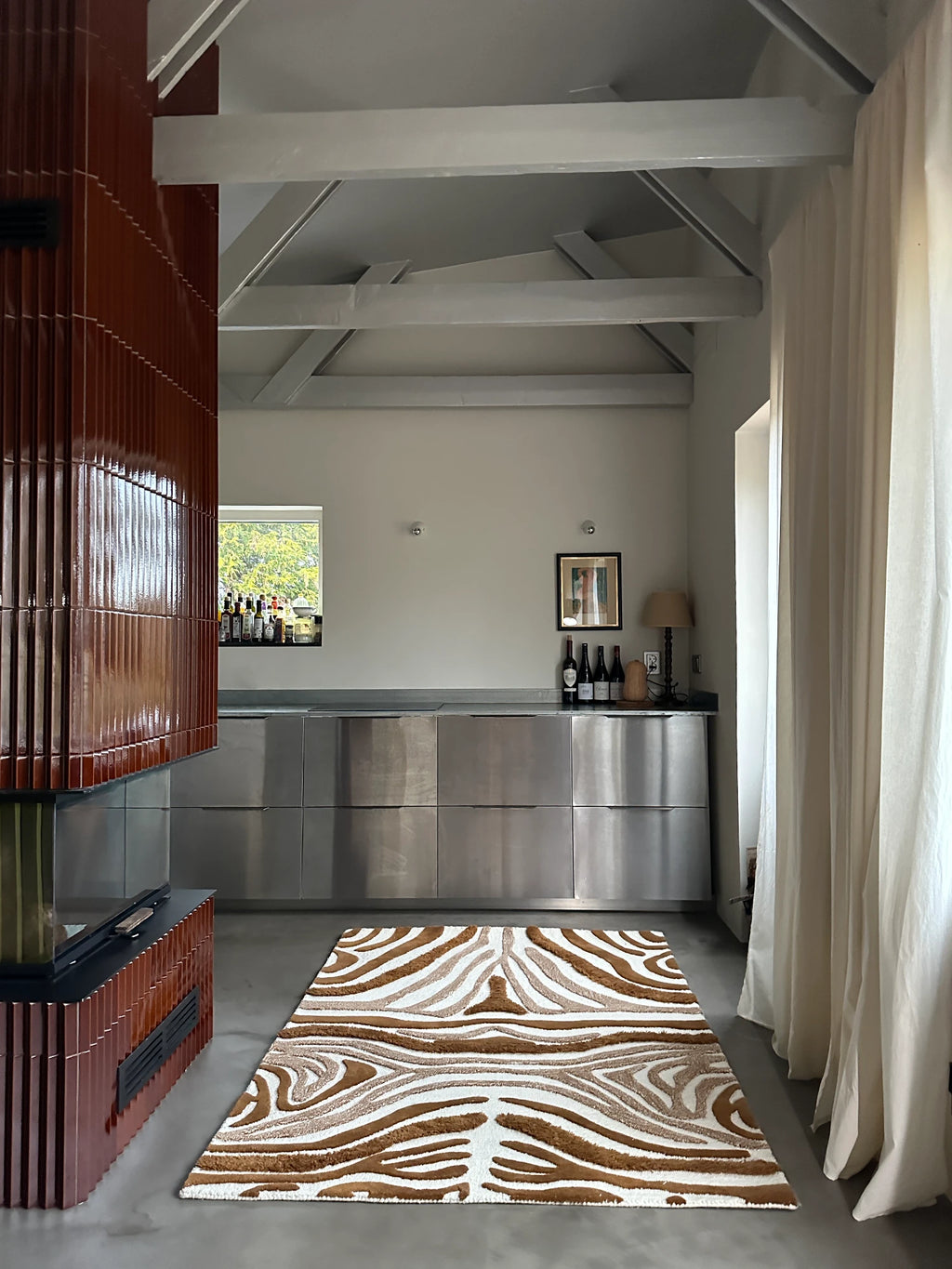 Tinted Objects Jepson Wool Rug, featuring a bold, abstract zebra pattern in plush brown and white natural wool fibers, providing a luxurious textured feel. This stylish area rug is perfect for adding a touch of modern sophistication and warmth to living rooms or bedrooms for design-conscious homeowners.