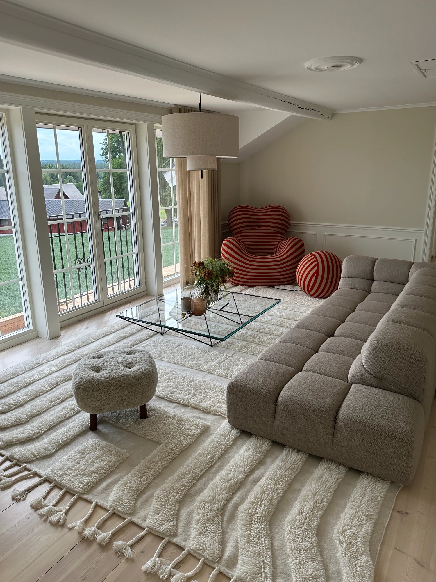Tinted Objects Kask Wool Rug, a hand-knotted cream wool area rug featuring a unique abstract pattern of raised, shaggy high-pile textured lines against a flat woven base, finished with decorative tassels along one edge. This organic modern natural fiber rug is perfect for adding warmth and minimalist style to Scandinavian living rooms, boho bedrooms, or contemporary spaces.