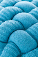 Knitted pouf stool in earthy tones made from high-quality yarn