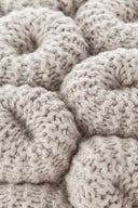 Round knitted stool in neutral tones ideal for rustic or boho interiors