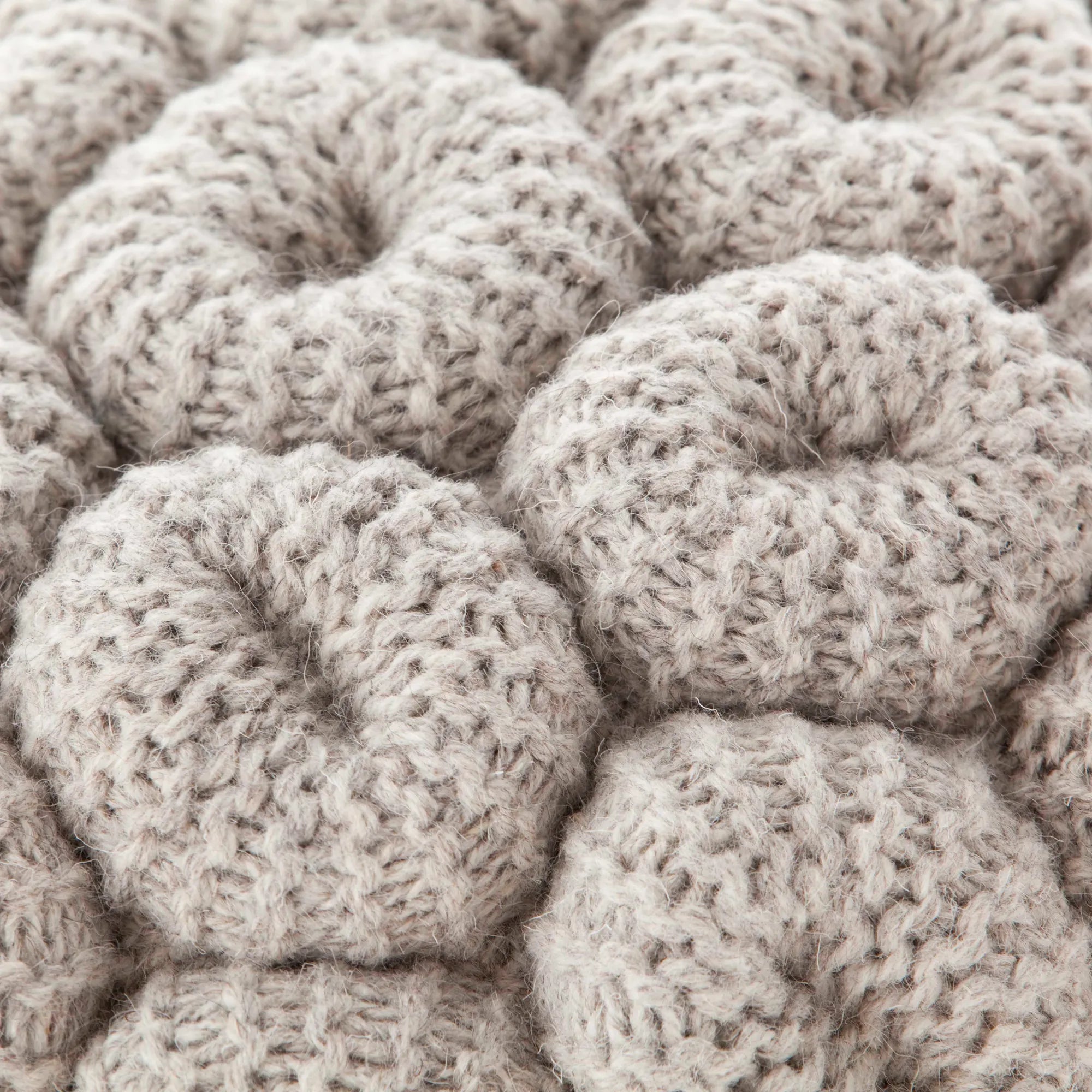 Round knitted stool in neutral tones ideal for rustic or boho interiors