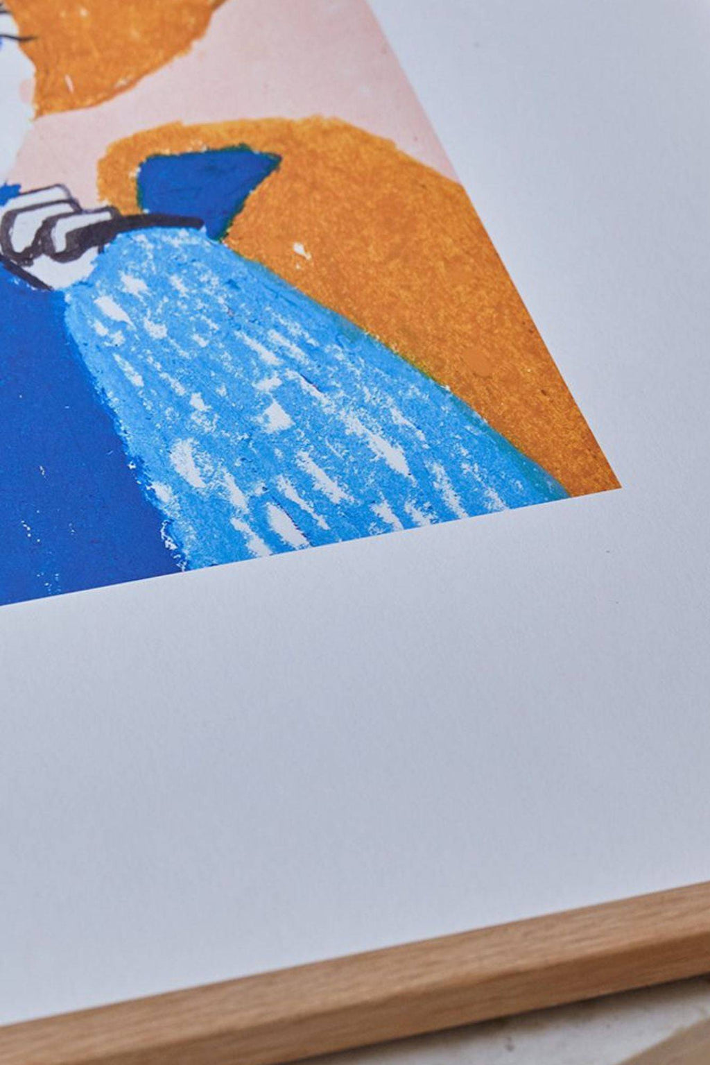 The Poster Club Woz, an abstract art print featuring bold graphic shapes with a vibrant royal blue, light blue, deep orange, and soft pink color palette, rendered with a distinctive crayon texture. This contemporary wall art is framed in a light natural oak frame, offering a playful yet modern accent to any room.