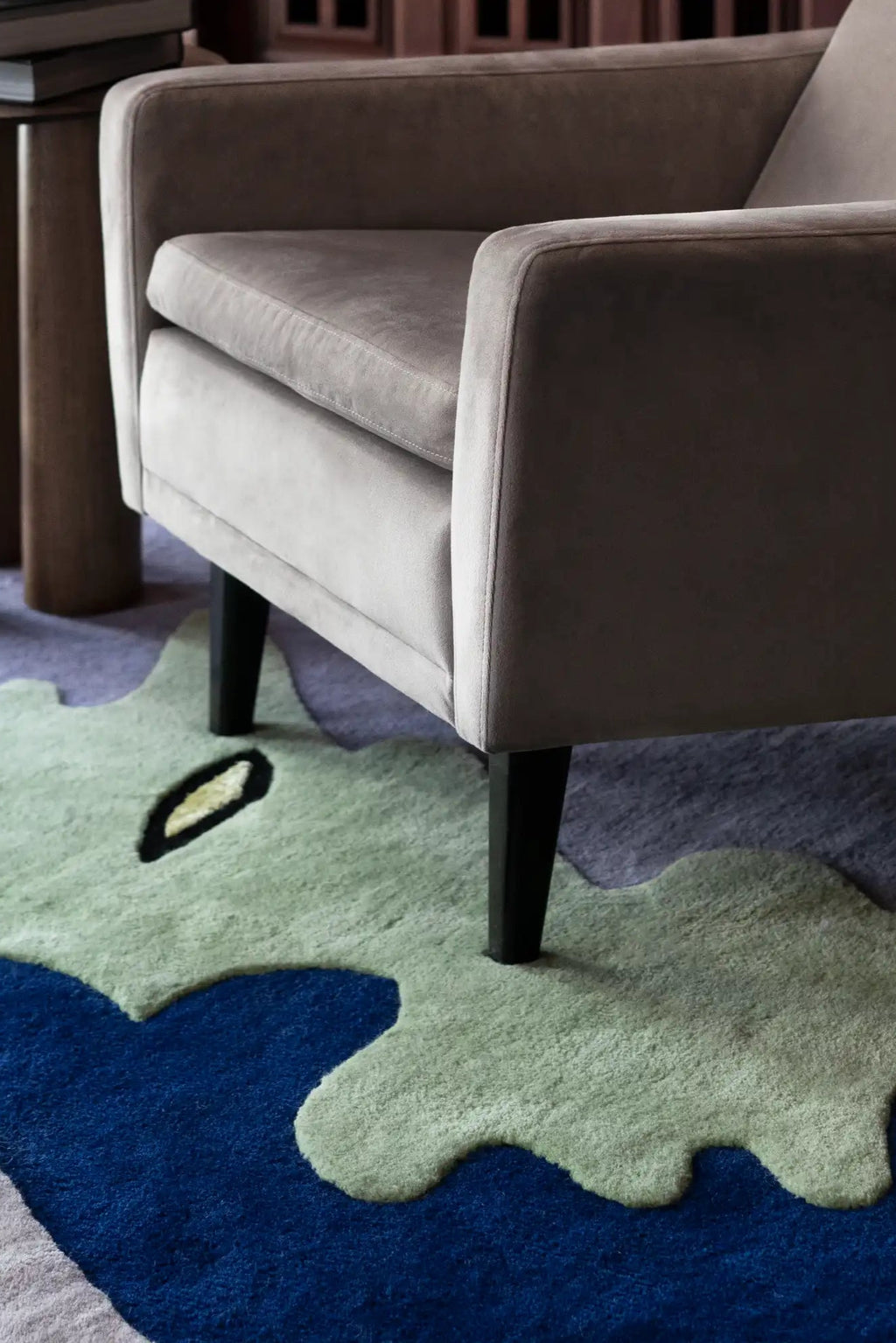 Layered Opera Goers Wool Rug, a vibrant modern area rug with an organic, abstract pattern in shades of blue, light green, and hints of black. Perfect for adding a bold, artistic statement to contem...