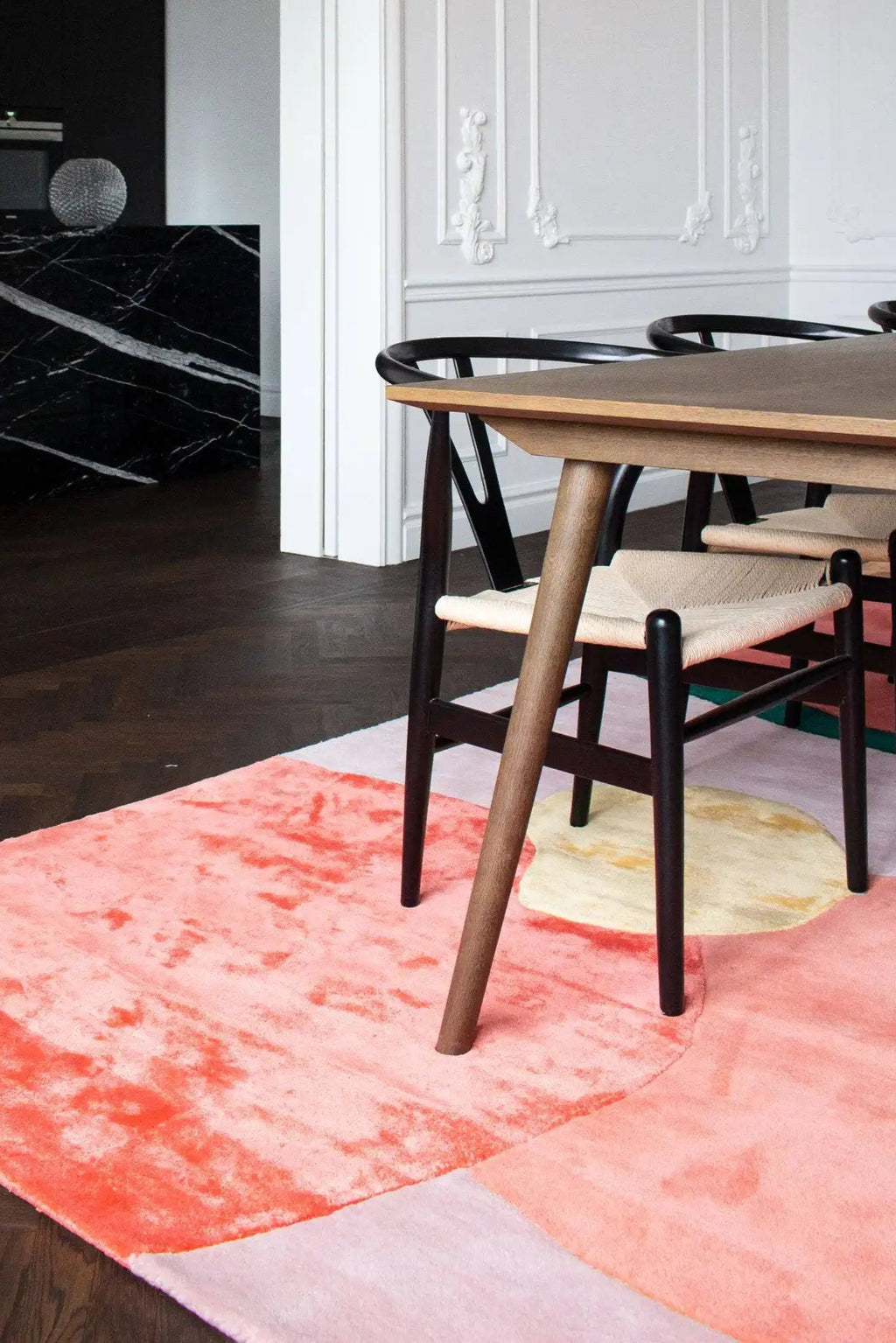 Layered Flower Field Wool Rug, a modern abstract area rug featuring vibrant coral, subtle pink, and warm yellow organic shapes with a soft texture. Perfect for adding a pop of color to any contempo...
