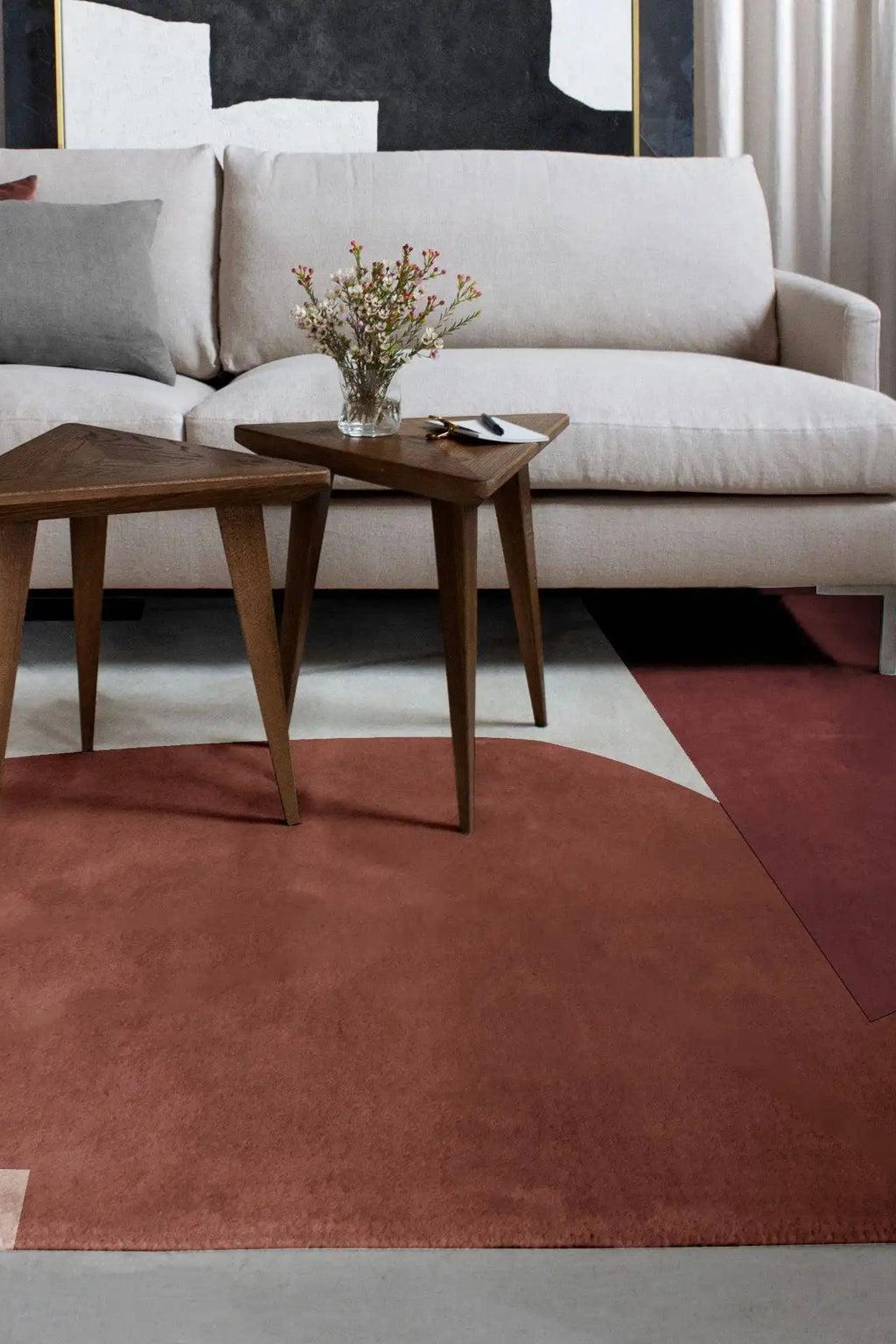 Layered Cloudberry Wool Rug, a plush, solid terracotta red area rug with a subtle texture, complementing modern living room decor. Perfect for adding warmth and sophisticated style to any home.