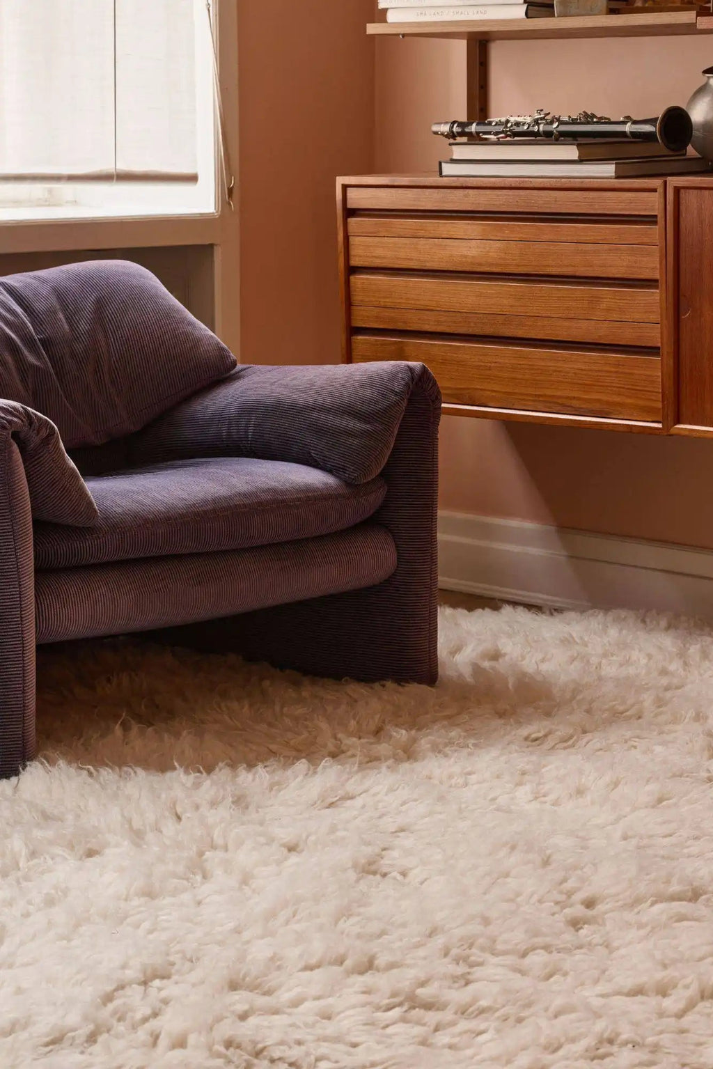 Layered Residue Shaggy Wool Rug, a plush off-white, cream-colored wool area rug with a deep, soft shaggy pile texture. Perfect for adding warmth and comfort to any living room or bedroom space.