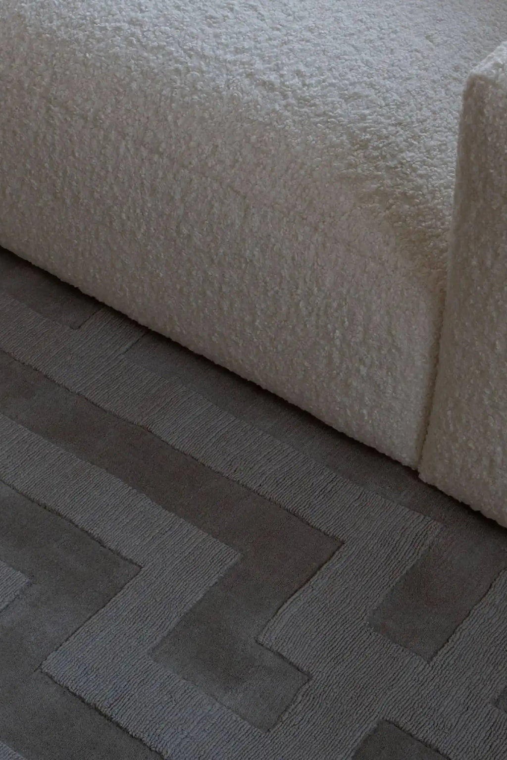 Layered Byzantine Grand Wool Rug, featuring a luxurious dark gray wool construction with a sophisticated raised geometric zigzag pattern. Perfect for adding texture and warmth to a modern living ro...