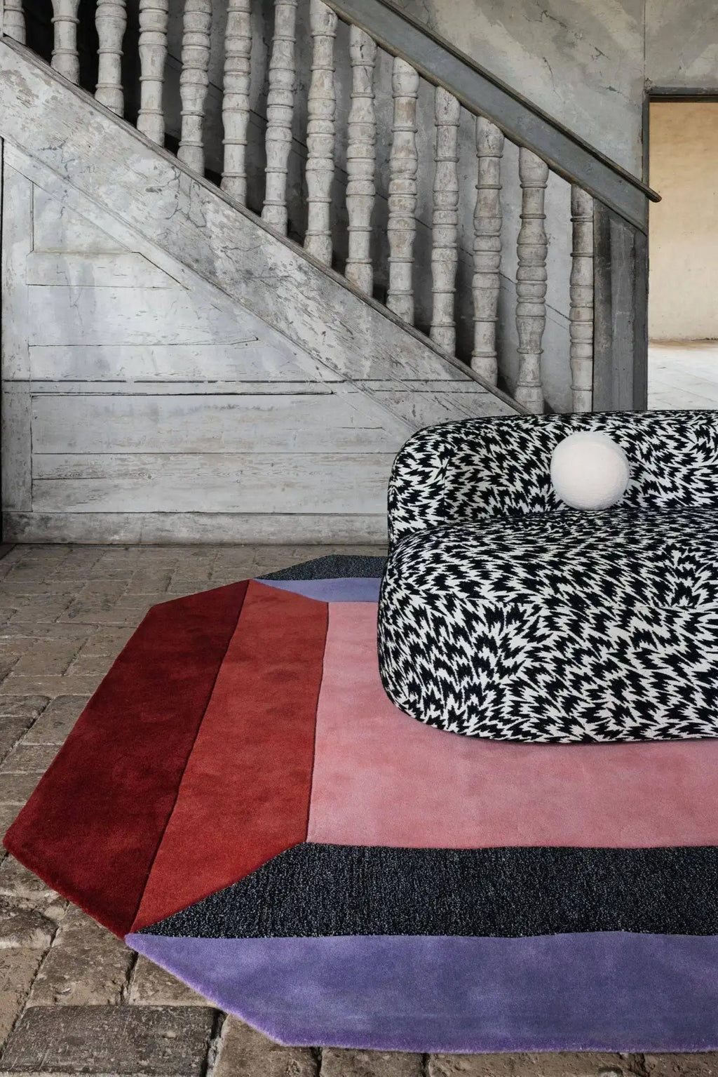 Layered Crystal Spectrum Wool Rug, a modern geometric area rug with color block design in shades of deep red, blush pink, dark gray, and lavender purple. Perfect for adding a vibrant, luxurious tou...