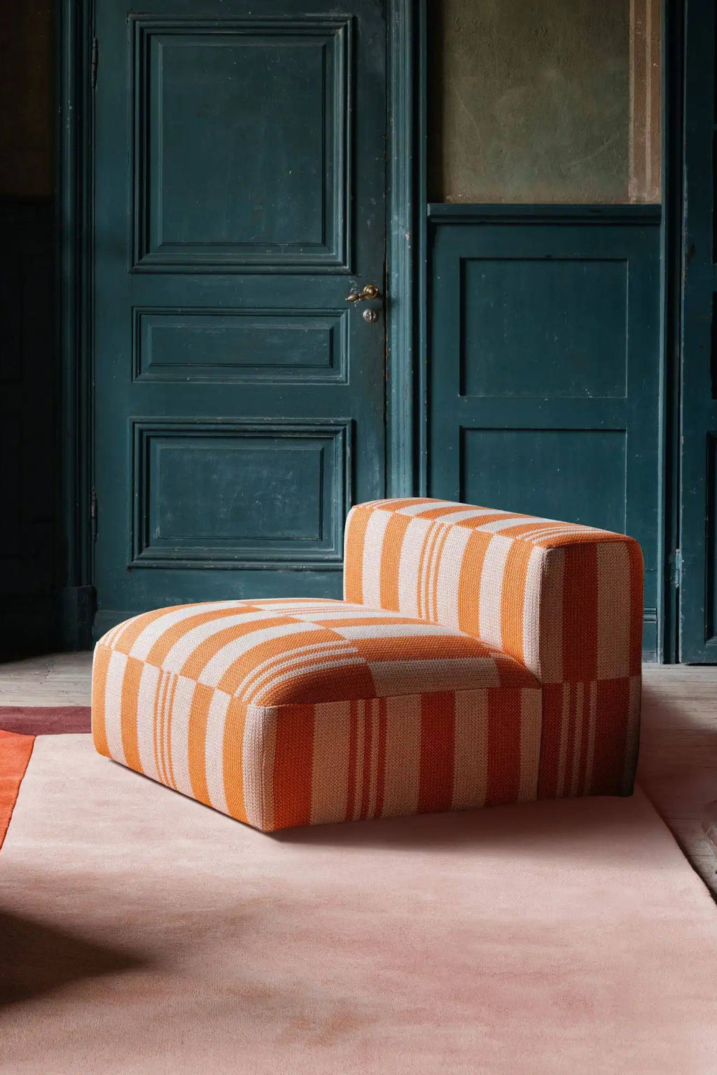 Layered Box Wool Rug, a plush pink and orange area rug with a subtle striped border, featuring a soft, luxurious texture. Perfect for adding warmth and sophisticated style to living rooms or bedrooms.