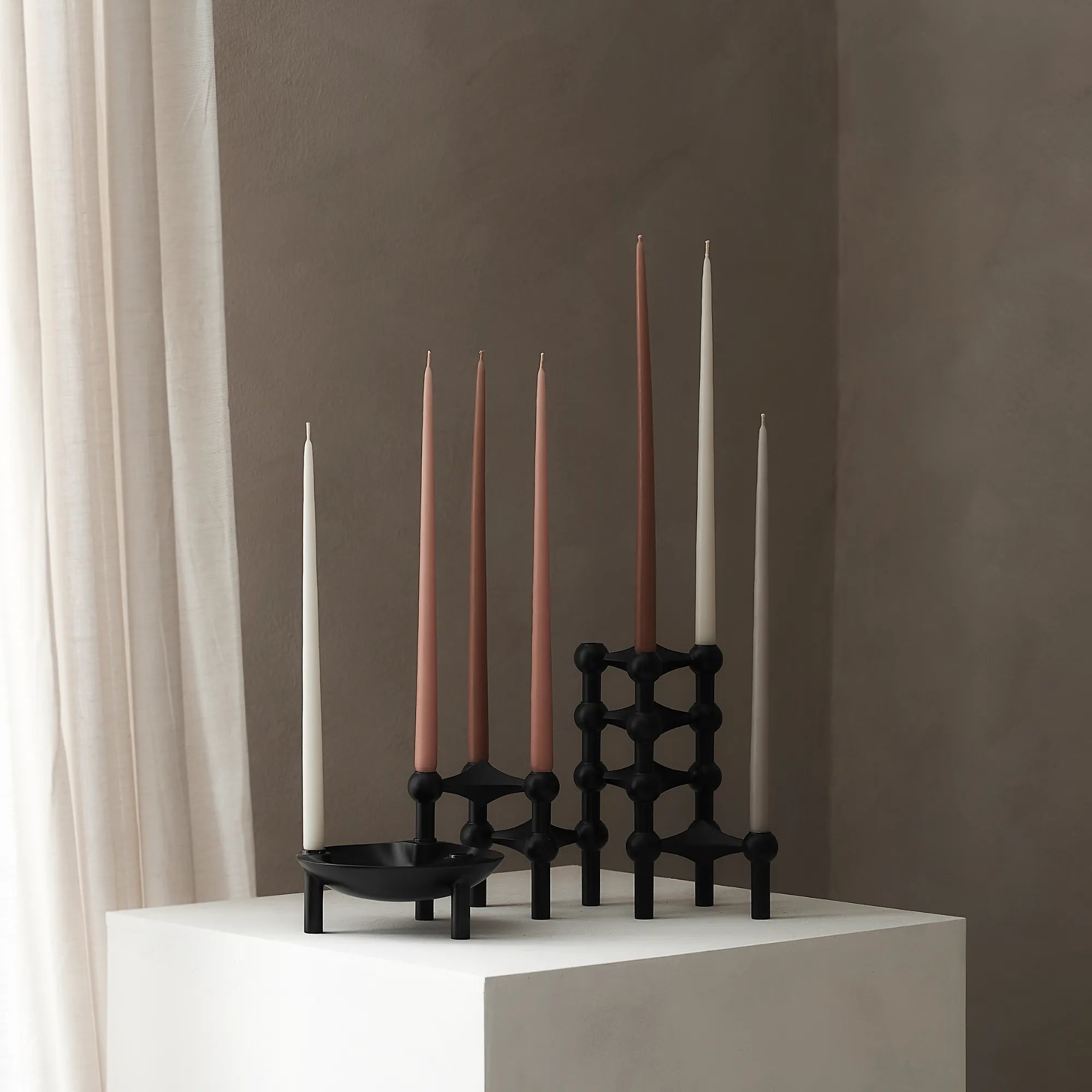 Contemporary black candle holder featuring a unique modular configuration for versatility