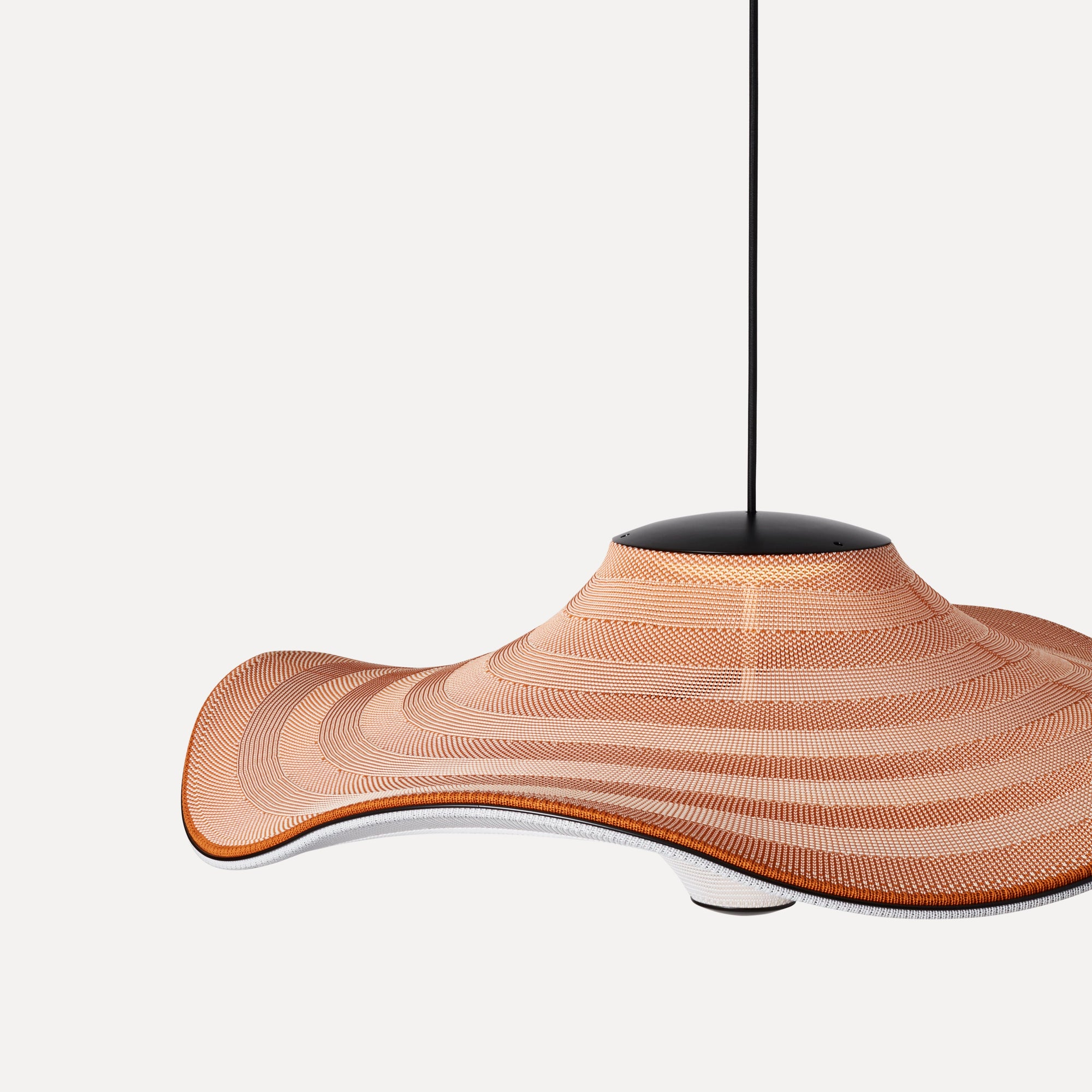 Made by Hand Flying Ø96 Pendant Lamp, a striking organic modern pendant lamp featuring a large, undulating hand-woven textile shade with a distinctive wavy silhouette and ribbed texture in warm terracotta and light cream tones. This sculptural ceiling light, suspended from a sleek matte black metal canopy, provides a dramatic yet soft aesthetic. Perfect as a statement piece for contemporary dining rooms, spacious living areas, or artistic minimalist interiors.