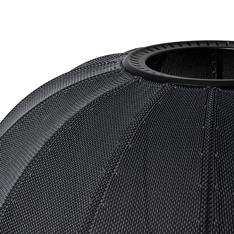 Made by Hand Knit-Wit Ø57 Oval Wall Light, a modern minimalist black wall lamp crafted from a unique knitted mesh textile with distinct ribbed segments and a spherical silhouette. This contemporary fabric light fixture provides soft ambient illumination for Scandinavian-inspired living rooms, bedrooms, or modern entryways.