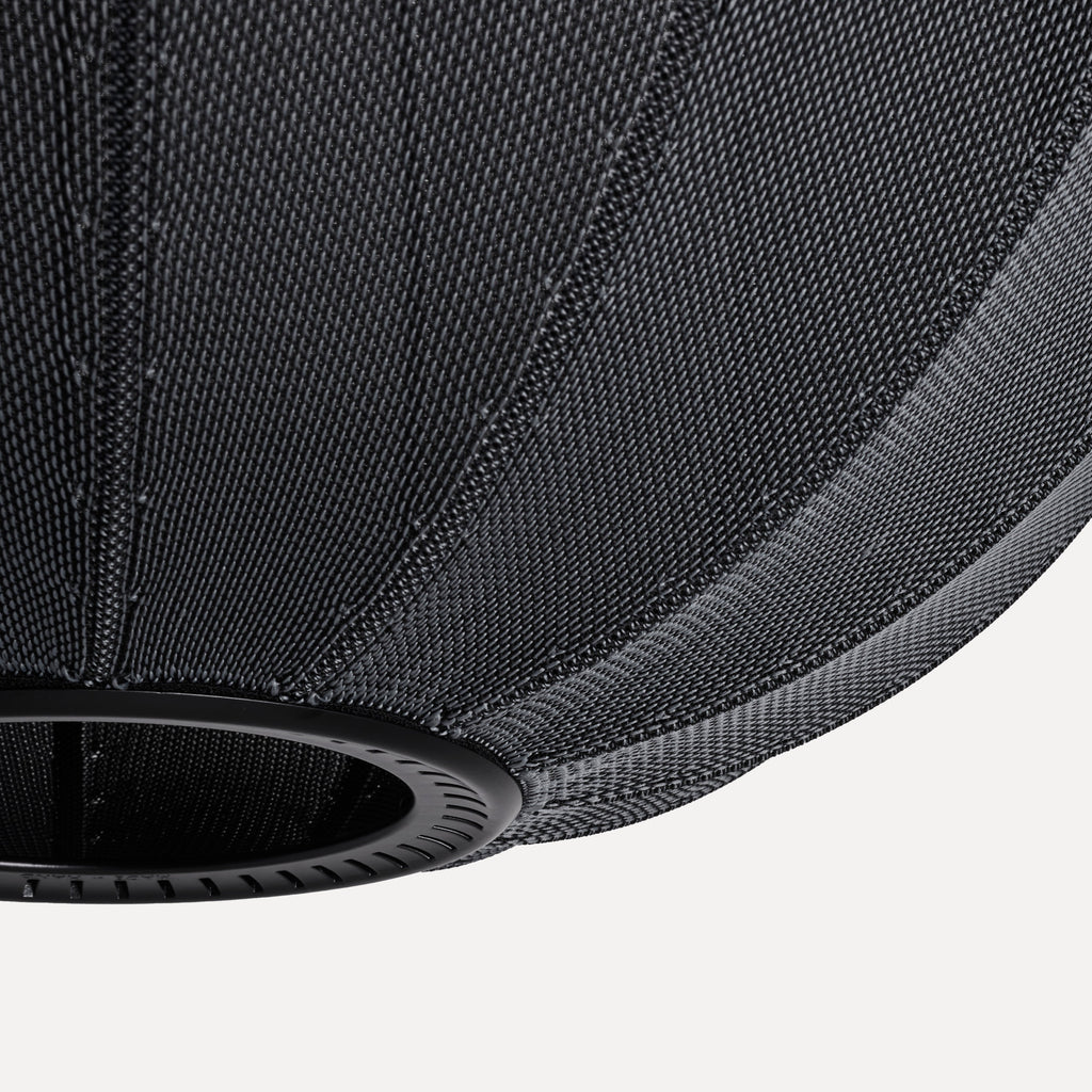 Made by Hand Knit-Wit Ø45 Oval Pendant Lamp, a modern minimalist ceiling light crafted from a unique dark grey knitted textile with a distinctive textured weave and soft, voluminous oval shape. This contemporary black pendant lamp features a subtle matte black metal detail at its base, offering a sophisticated touch. Ideal for Scandinavian living rooms, organic modern dining areas, or cozy bedroom lighting.