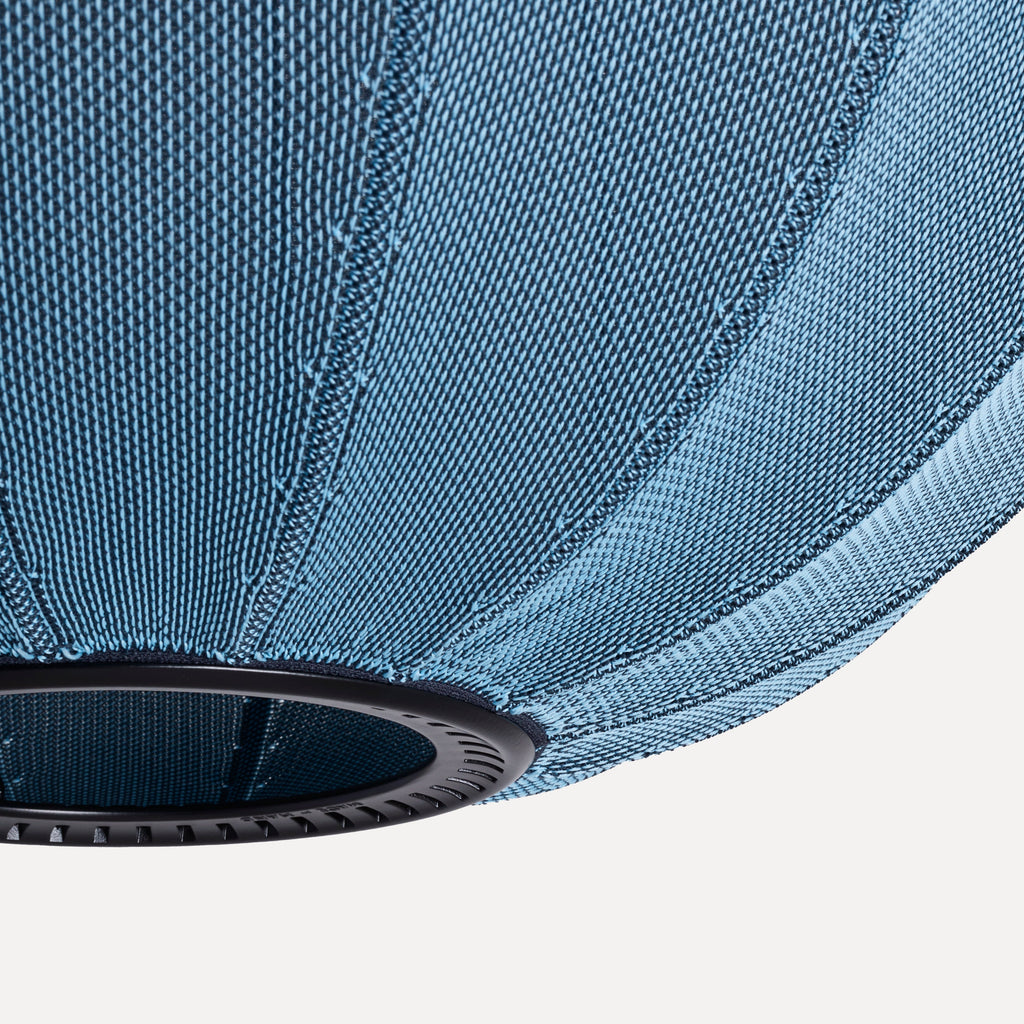 Made by Hand Knit-Wit Ø45 Oval Pendant Lamp, a modern Scandinavian ceiling light featuring a unique light blue knitted textile shade with a distinct two-tone woven pattern and subtle vertical ribbing. This organic oval hanging lamp provides soft, inviting ambient light, perfect for a contemporary living room, dining room, or bedroom accent.