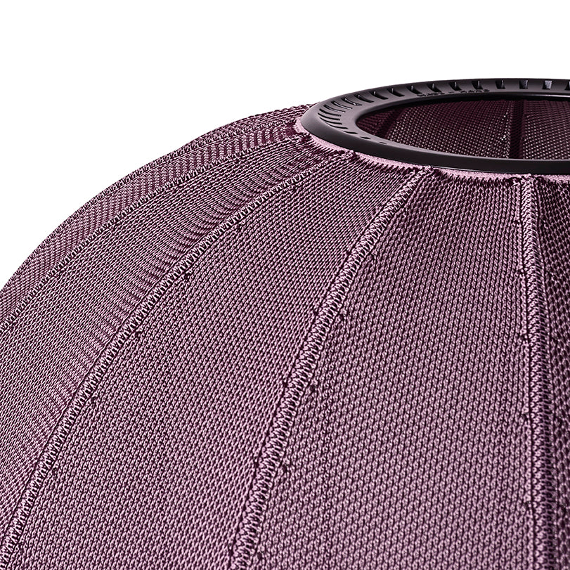 Made by Hand Knit-Wit Ø76 Oval Wall Light, a contemporary Scandinavian wall lamp featuring a finely knitted textile shade in a muted mauve or dusty rose color, crafted with a distinctive ribbed texture that defines.
