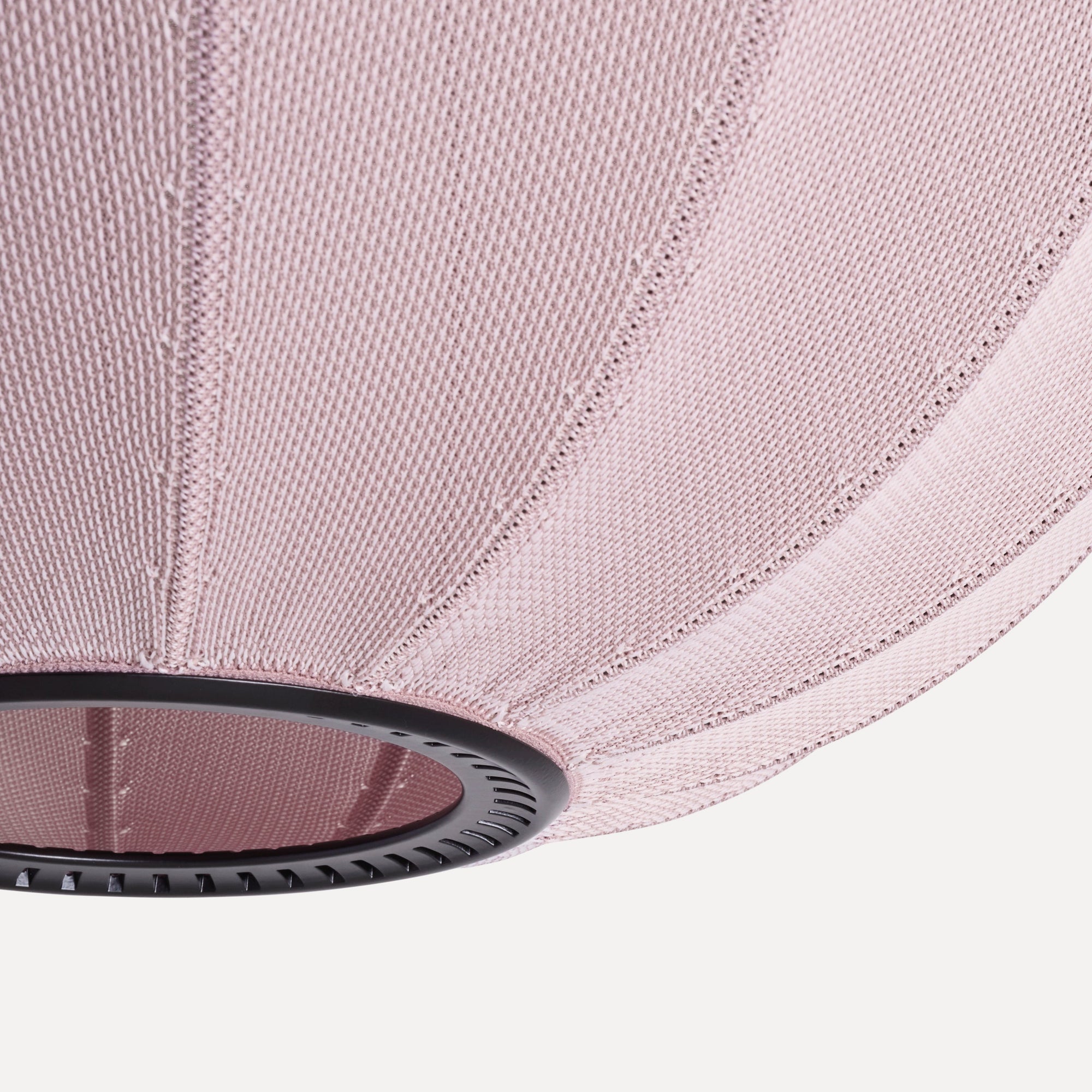 Made by Hand Knit-Wit Ø45 Oval Pendant Lamp, a dusty rose knitted fabric pendant light with a finely textured, ribbed surface and a matte black metal ring accent. This modern Scandinavian oval lamp provides soft ambient lighting for contemporary living rooms, minimalist bedrooms, or stylish nursery decor.
