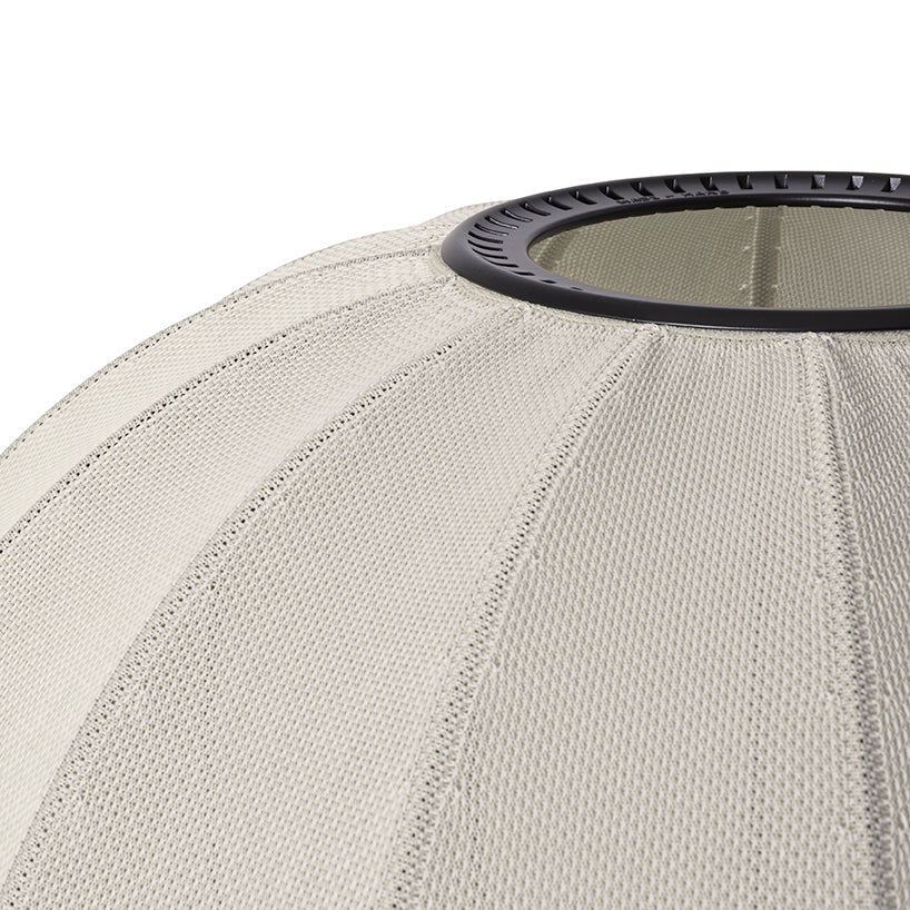 Made by Hand Knit-Wit Ø45 Oval Wall Light, a Scandinavian-inspired wall lamp featuring a soft, domed oval shape crafted from a cream-colored knitted fabric with a distinct ribbed texture and a dark circular rim. This organic modern textile light is perfect for cozy bedroom accent lighting or contemporary living room spaces.