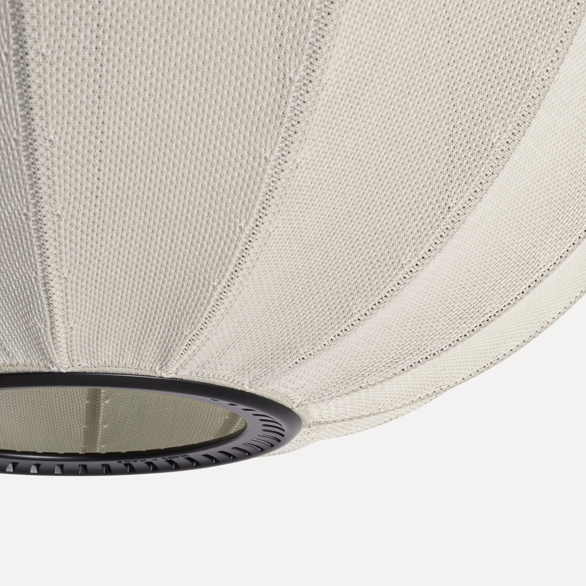 Made by Hand Knit-Wit Ø45 Oval Pendant Lamp, a contemporary ceiling light featuring a textured light beige knitted fabric shade with distinct vertical ribbed detailing and a subtle, soft glow, supported by a sleek matte black.