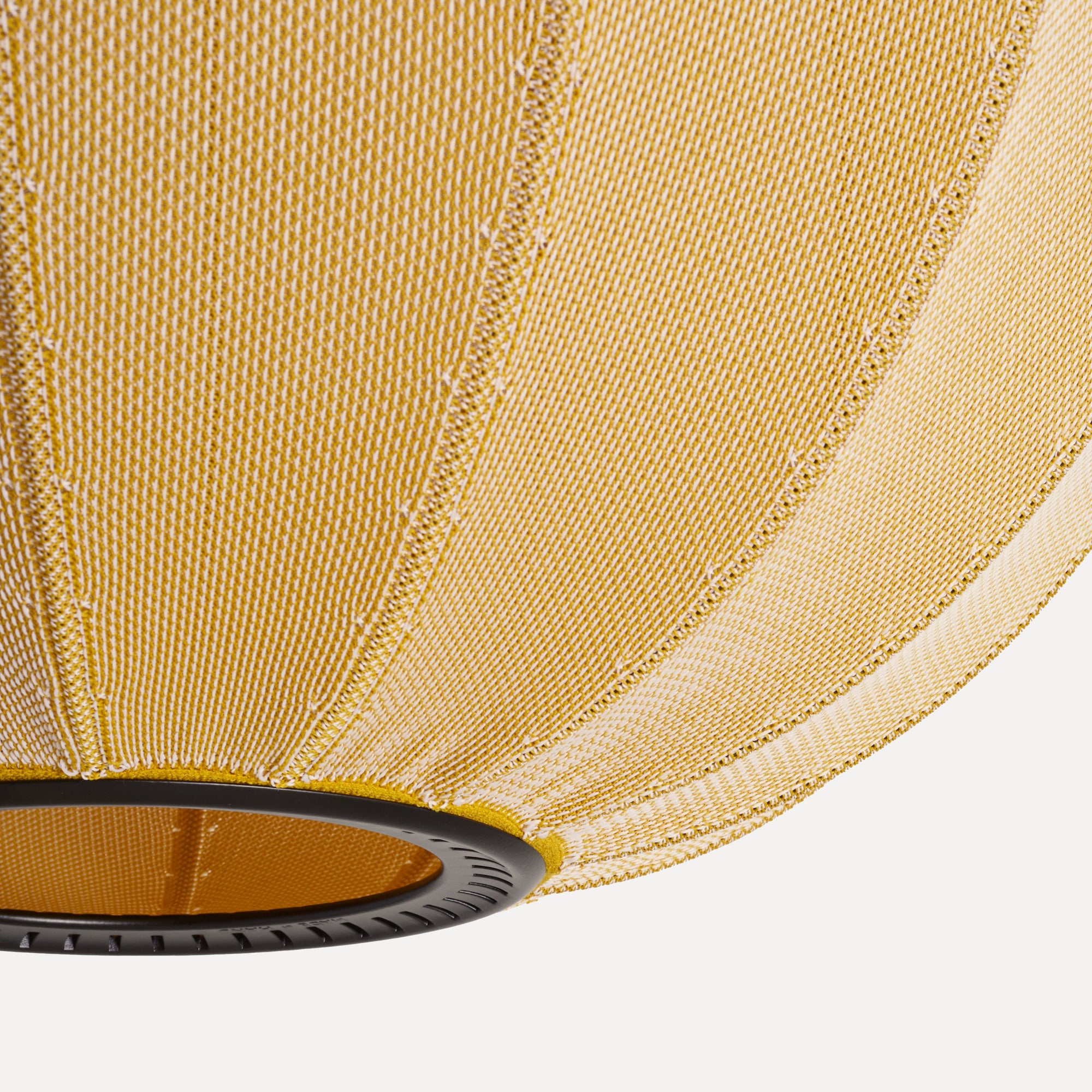 Made by Hand Knit-Wit Ø45 Oval Pendant Lamp, a modern minimalist pendant lamp featuring a unique hand-knitted shade in a warm mustard yellow and white textured yarn, forming a soft, rounded oval silhouette with distinct vertical ribs. The permeable knitted textile creates a diffused, inviting light, ideal for adding a touch of Scandinavian design or organic modern flair to living rooms, dining areas, or bedrooms.