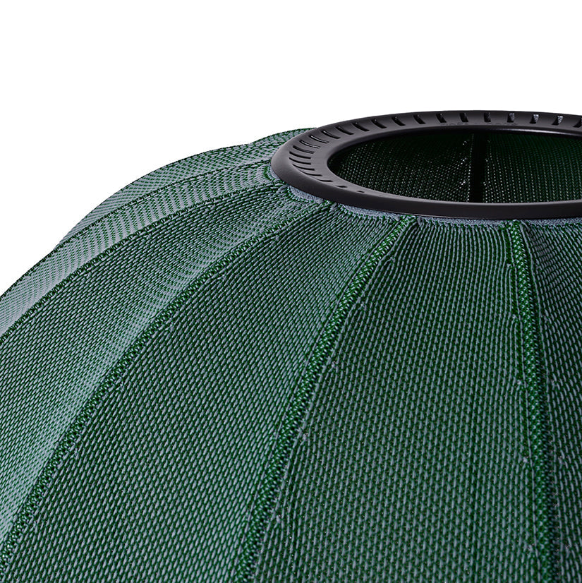 Made by Hand Knit-Wit Ø57 Oval Wall Light, a modern minimalist wall light featuring a deep forest green knitted textile shade with a distinct ribbed fabric texture and a sturdy black metal ring at the top. This Scandinavian design oval lamp provides warm ambient lighting, perfect for living room accent lighting, a cozy bedroom, or a stylish hallway.