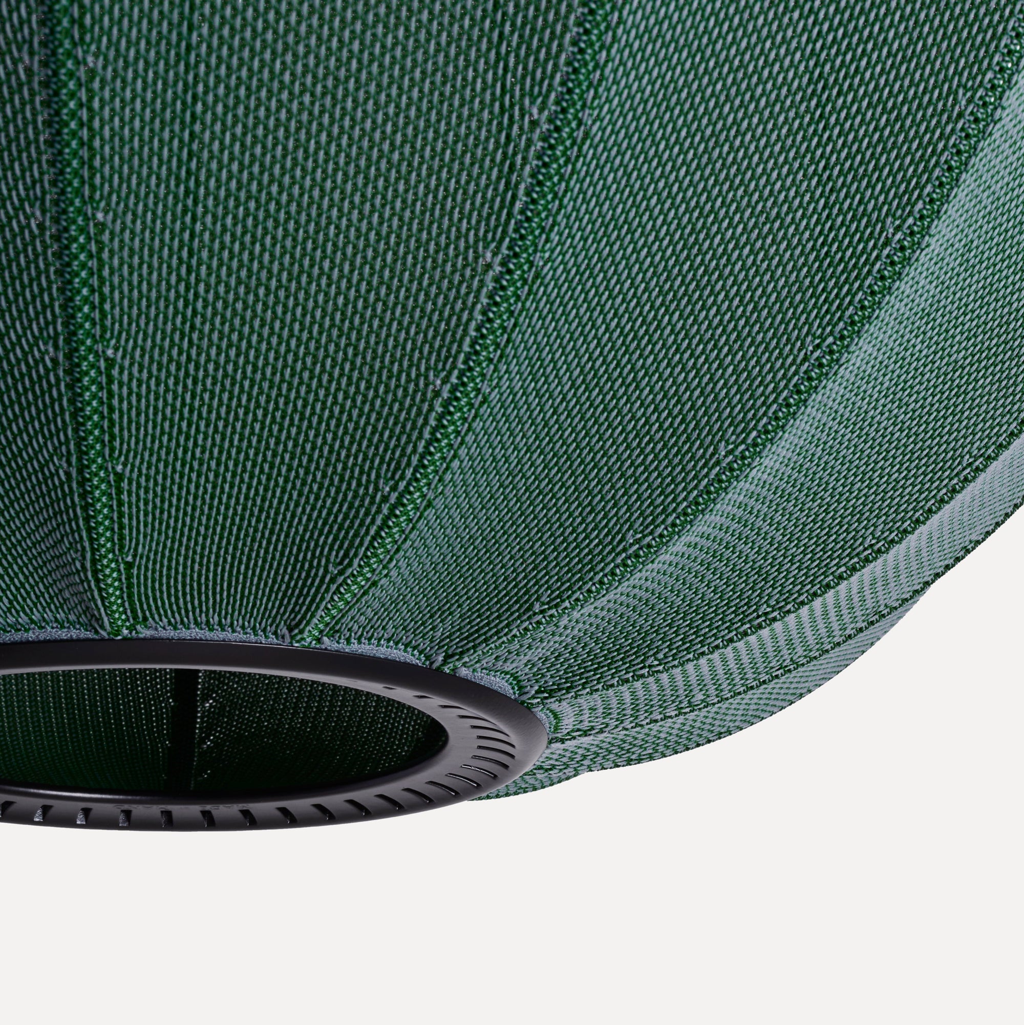 Made by Hand Knit-Wit Ø45 Oval Pendant Lamp, a modern Scandinavian pendant lamp featuring a dark green knitted textile shade with a distinct ribbed texture and a contrasting black metal ring. This contemporary oval ceiling light provides soft, diffused illumination, perfect for a minimalist living room or as a stylish dining room accent.
