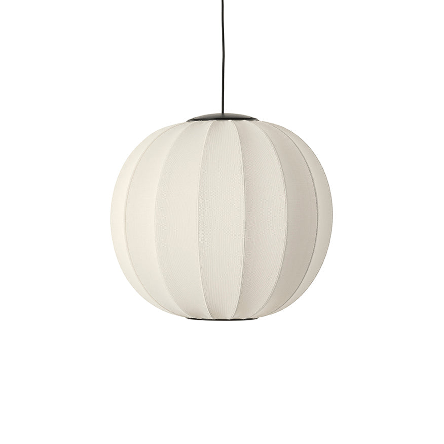 Made by Hand Knit-Wit Ø60 Round Pendant Lamp, a modern minimalist spherical pendant lamp featuring a finely knitted off-white textile shade with distinct vertical ribbed detailing, complemented by sleek matte black metal caps and suspension cord.