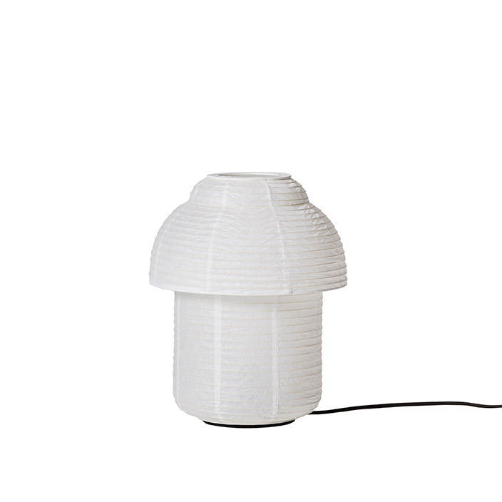 Made by Hand Papier Double Ø30 Table Lamp, a minimalist white paper table lamp with a distinctive double-layered, mushroom-like silhouette and a finely pleated, ribbed texture. This organic modern design, crafted from natural paper, provides soft, ambient light. Ideal as a Japandi bedside lamp, Scandinavian living room accent, or contemporary desk lighting.
