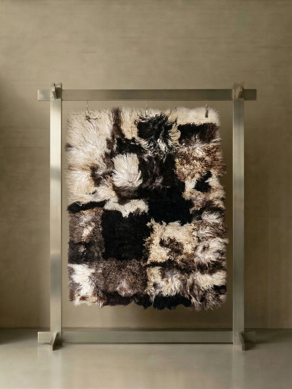 TCL Studios Curly Sheepskin Patchwork Rug, a luxurious and plush multi-color sheepskin area rug featuring a dynamic patchwork design of natural curly sheepskin in rich shades of cream, black,.