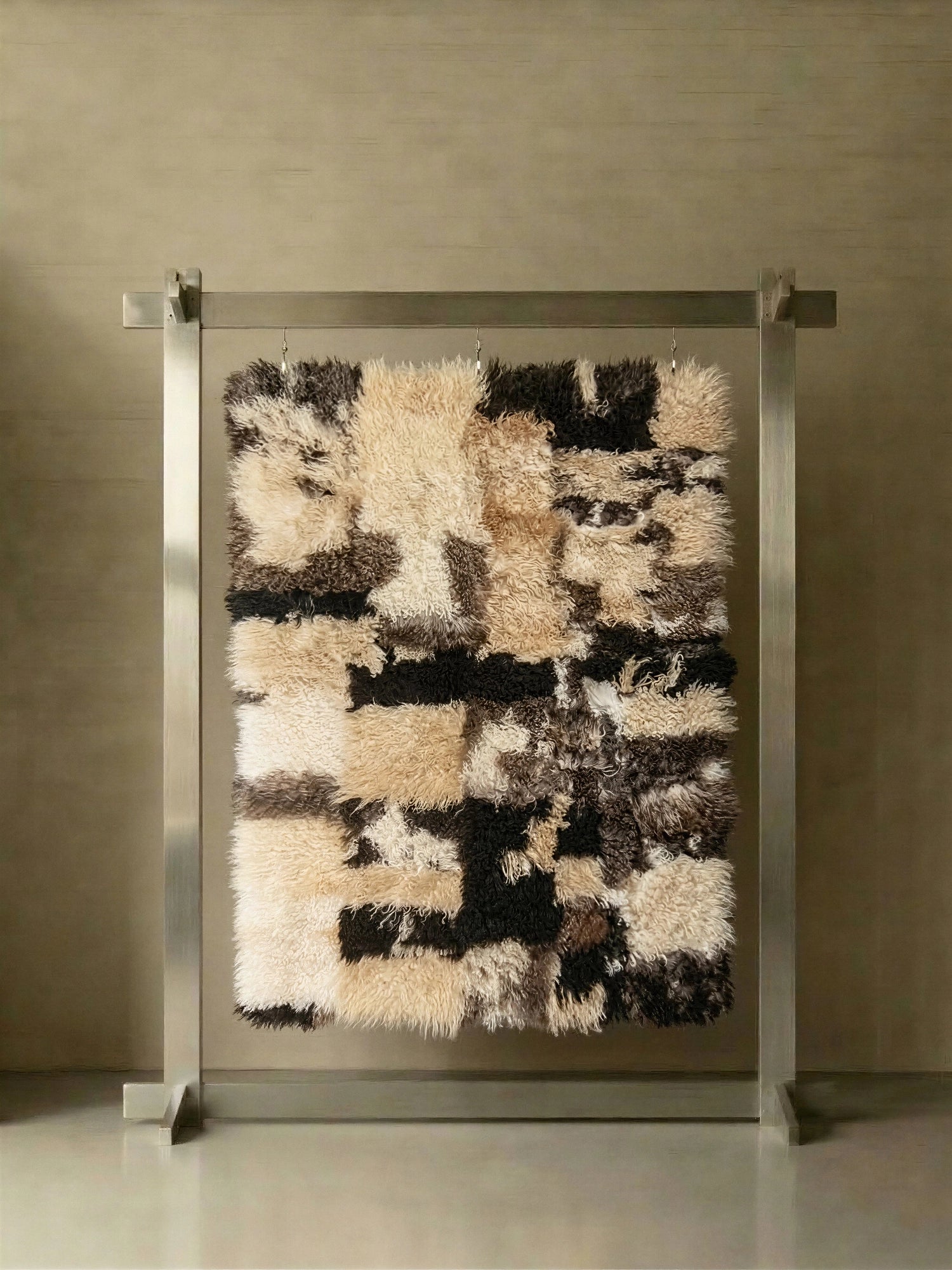 TCL Studios Curly Sheepskin Patchwork Rug, a plush rectangular area rug crafted from natural curly sheepskin in a multi-tone patchwork design featuring cream, light beige, and dark brown hues. This textural, shaggy sheepskin rug offers an organic modern aesthetic, perfect for adding warmth and coziness to contemporary living rooms or Scandinavian bedrooms.
