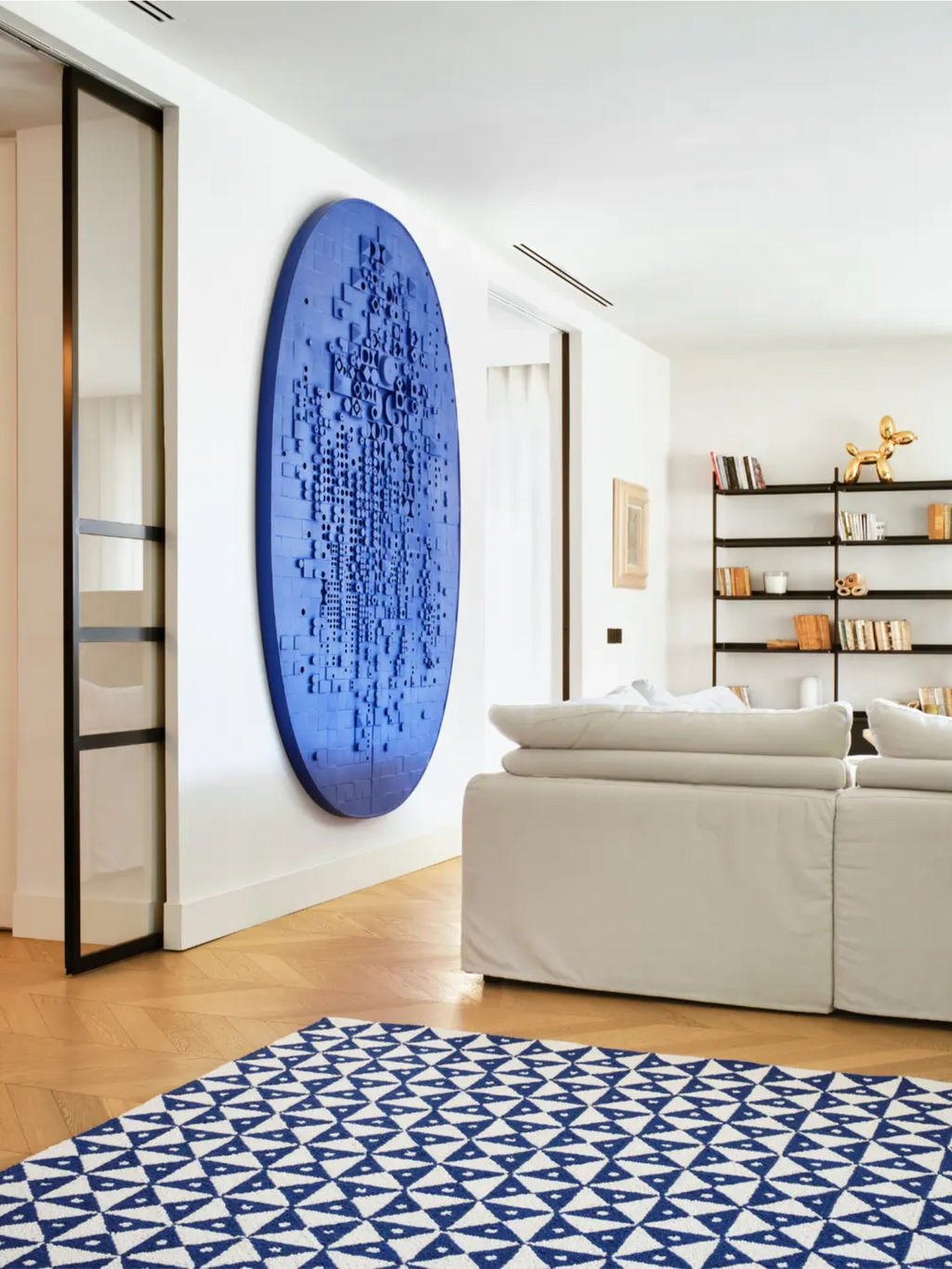 alp_ Mosaic Signature Rug, a vibrant cobalt blue and white woven area rug showcasing a striking geometric mosaic pattern of interlocking triangles.