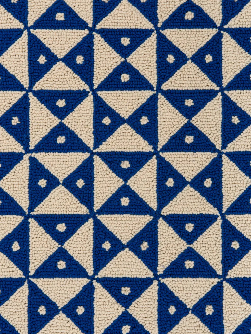alp_ Mosaic Signature Rug, a vibrant hand-tufted loop pile wool rug featuring a bold geometric mosaic pattern of interlocking royal blue and cream triangles.