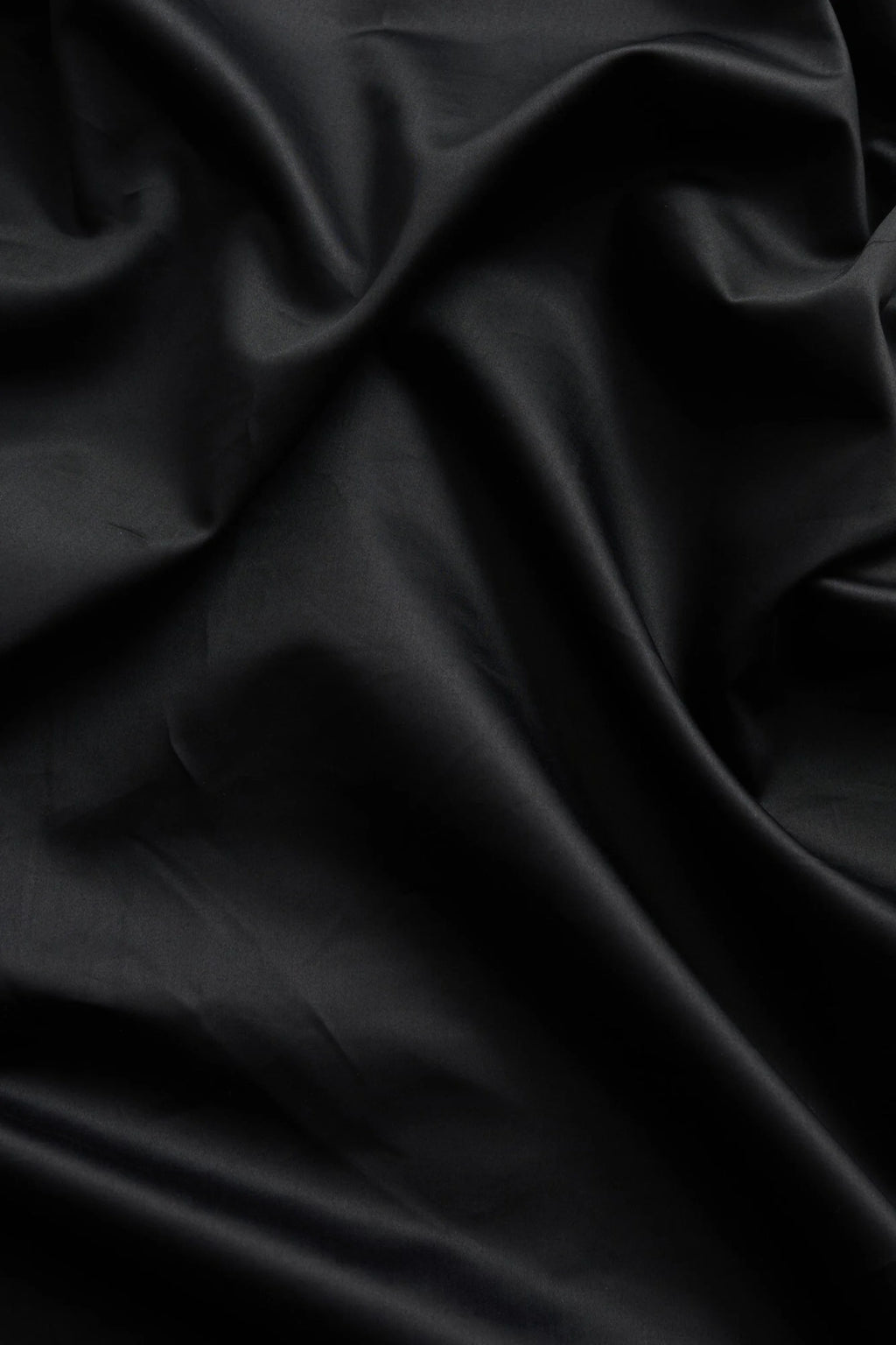 Magniberg Mother Sateen Flat Sheet, a luxurious deep black sateen flat sheet crafted from high-quality cotton with a silky-smooth, lustrous finish and soft, flowing drape.