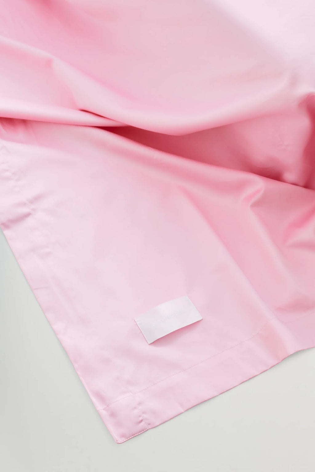 Magniberg Mother Sateen Flat Sheet, a luxurious light pink sateen flat sheet crafted from smooth, silky fabric with a lustrous finish and soft drape. This high-quality bedding offers a modern, elegant look for any bedroom, perfect for creating a cozy and contemporary aesthetic.