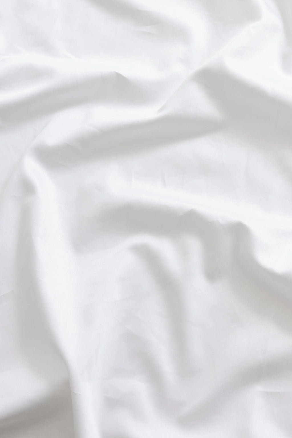 Magniberg Mother Sateen Flat Sheet, a crisp white flat sheet crafted from luxurious cotton sateen fabric, featuring a smooth, soft texture and subtle sheen that drapes fluidly with gentle wrinkles. This premium white bedding is ideal for creating a minimalist and contemporary bedroom aesthetic.