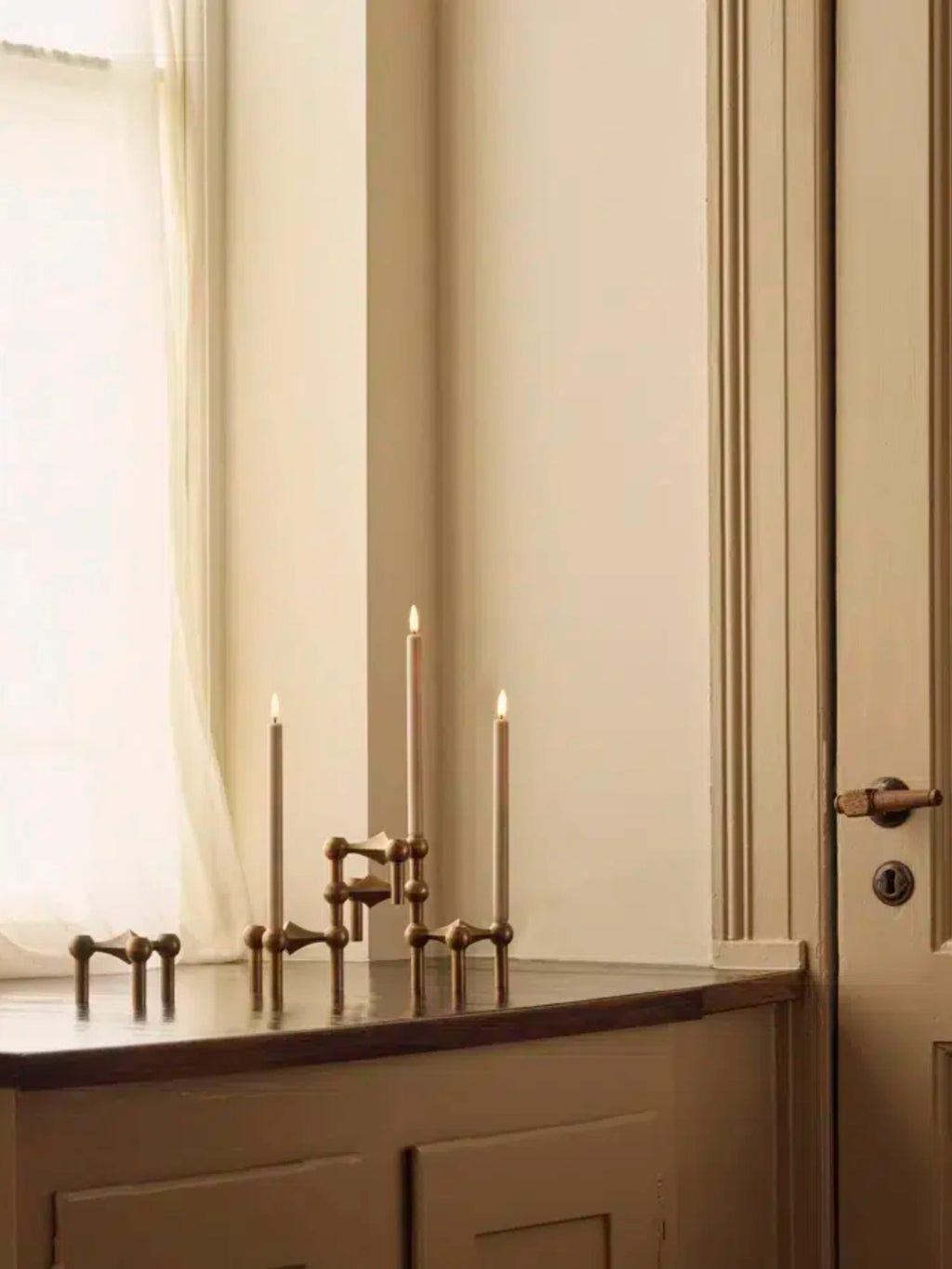 Stoff Nagel LED Candles - Set of 2, a pair of realistic light beige flameless taper candles featuring a smooth wax-like finish and warm flickering LED flames, designed to fit classic candle holders and candelabras. Perfect for creating a cozy ambiance in modern minimalist living rooms, Scandinavian-inspired dining spaces, or as a safe bedroom accent.