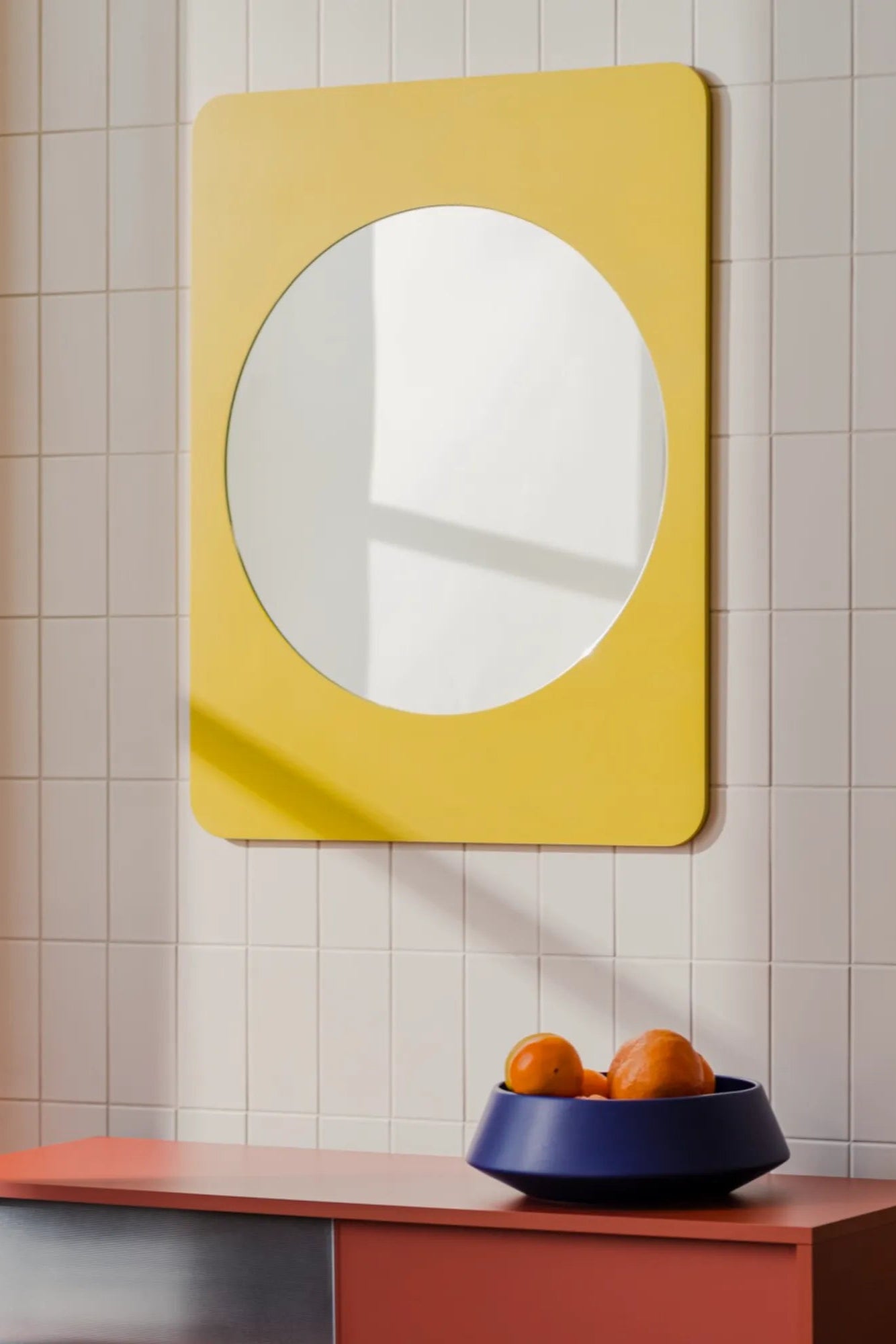 Aku Mirror with gold frame and geometric design reflecting room interior