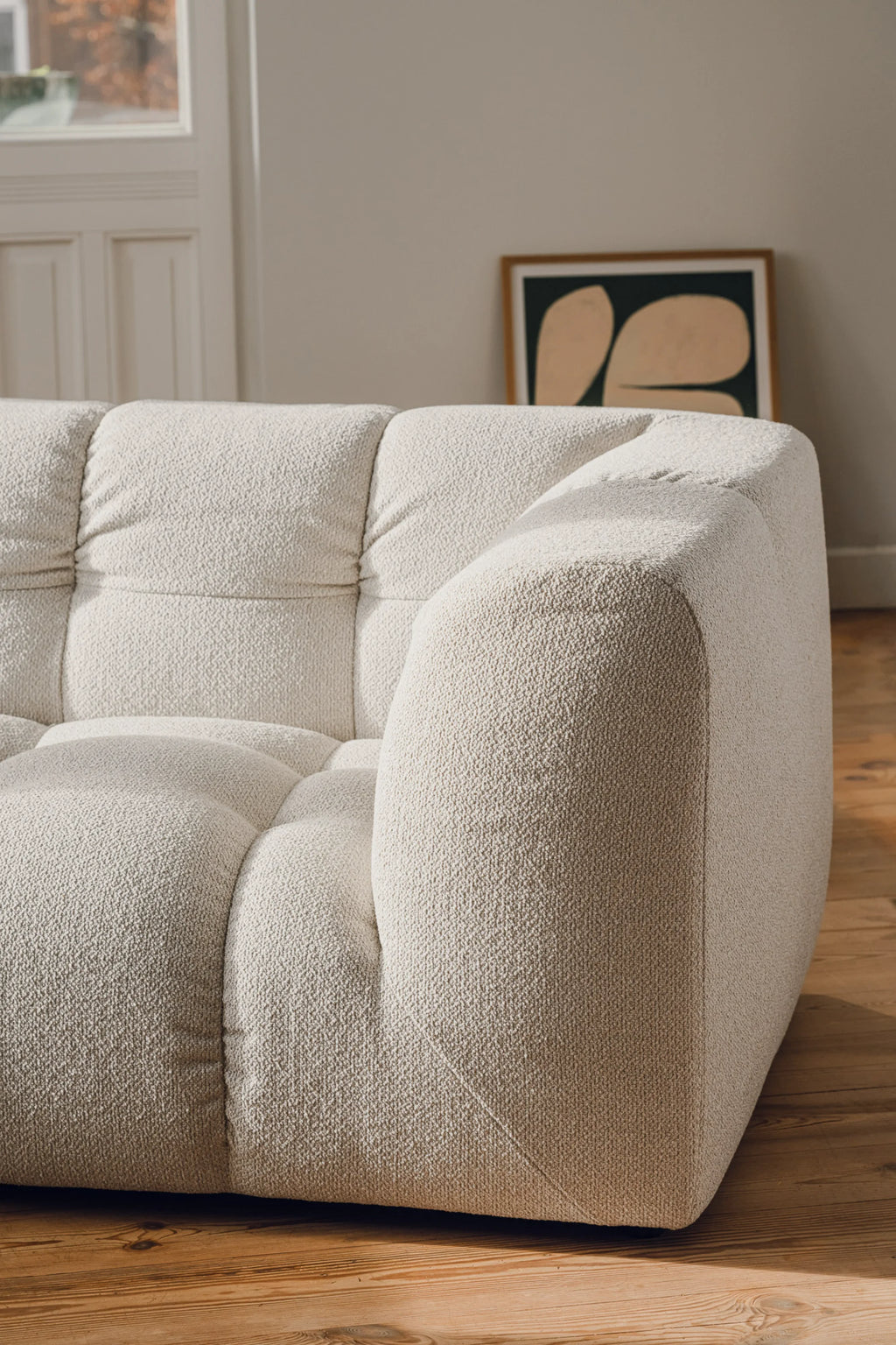 noo.ma Bolbi Sofa 2-seater, a contemporary 2-seater sofa upholstered in a plush, textured cream bouclé fabric, featuring distinctive tufted cushions and soft, rounded organic curves. This low-profile sofa offers deep, inviting seating in a natural off-white tone. It's an ideal piece for creating a cozy living room, minimalist apartment, or organic modern lounge space.