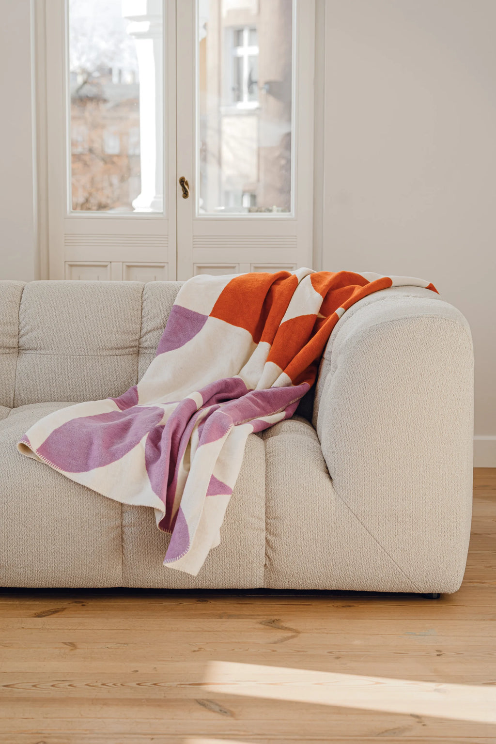 noo.ma Bolbi Sofa 2-seater, a contemporary organic modern sofa upholstered in a light cream bouclé fabric with a soft, textured weave and distinctive modular-style tufting. This inviting low-profile couch features a gently curved silhouette and rounded arms, perfect for minimalist living rooms, apartment spaces, or cozy modern lounge areas.