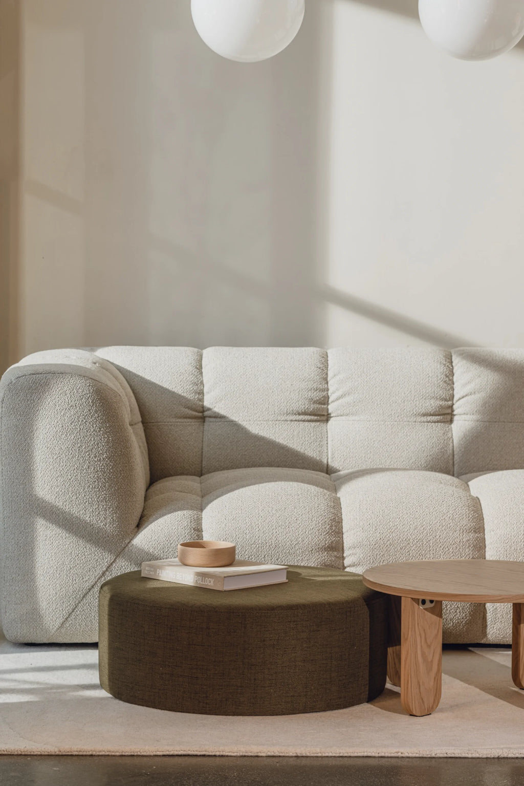 noo.ma Bolbi Sofa 2-seater, a contemporary organic modern sofa upholstered in a creamy, textured bouclé fabric with a distinctive tufted design and softly rounded arms. This compact 2-seater sofa features deep, plush seating, making it an inviting focal point for minimalist living rooms or cozy modern spaces.