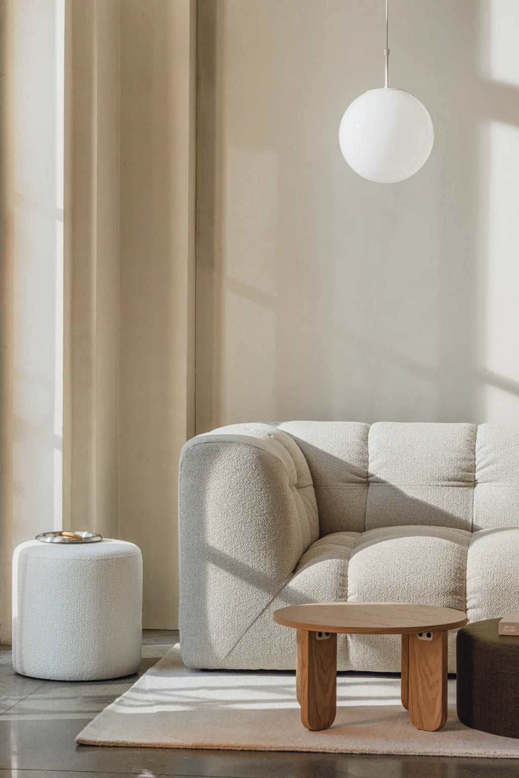 noo.ma Bolbi Sofa 2-seater, a contemporary organic modern sofa upholstered in a light beige bouclé fabric with a plush, textured weave and distinctive deep-tufted cushions. This cozy 2-seater sofa features a softly curved profile and inviting deep seating, perfect for a minimalist living room or a stylish lounge area.